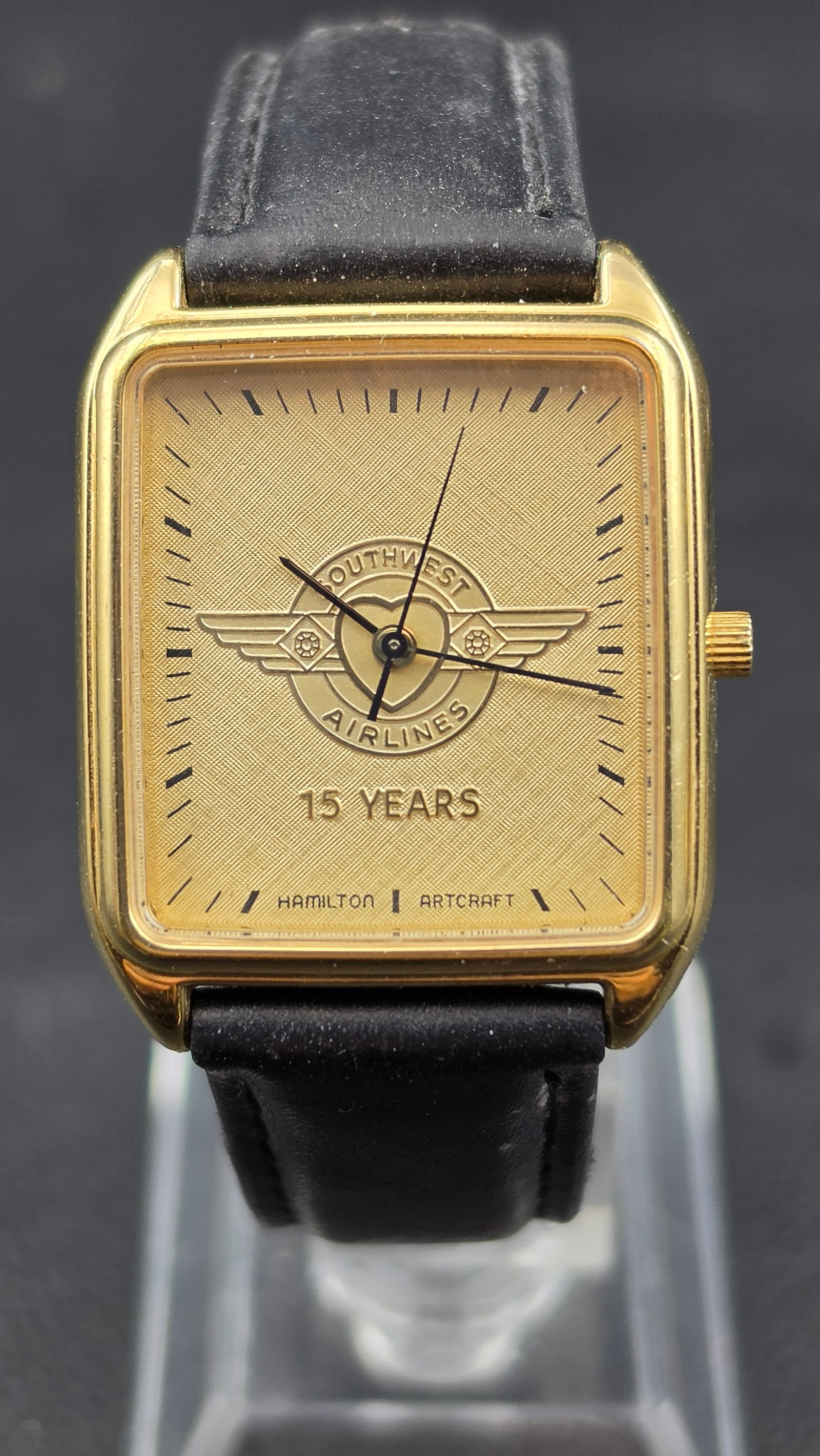 Hamilton Southwest Airlines 15 Years Award Quartz Watch 28mm Gold Tone Running: Hamilton Artcraft quartz wristwatch featuring a Southwest Airlines 15 Years service award dial with winged logo motif. Gold-tone rectangular case with textured dial and applied indices. The watch is r