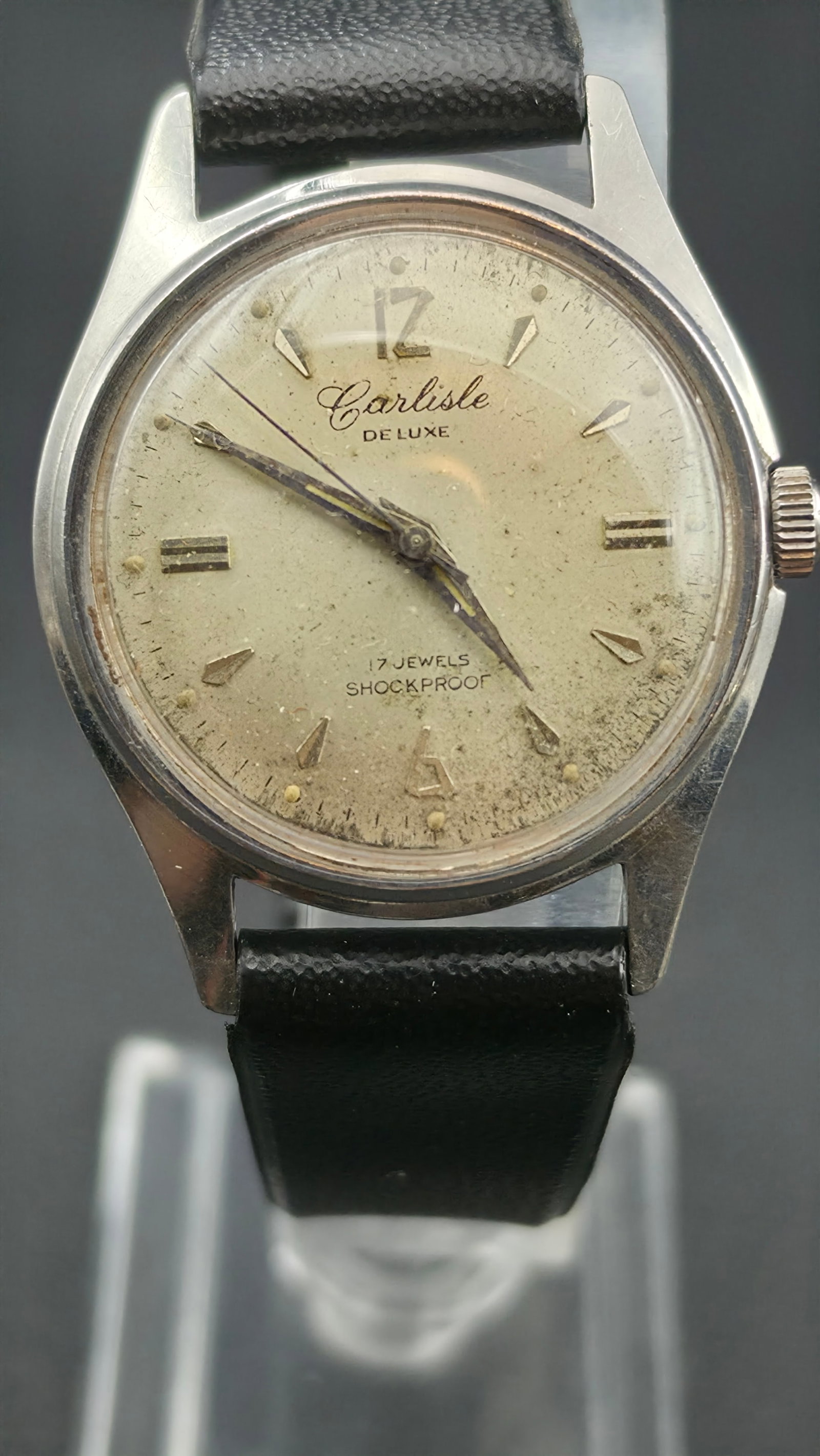 Carlisle De Luxe 17 Jewels Shockproof Manual Wind Stainless Steel 33mm 1950s Runs: This is a vintage Carlisle De Luxe manual wind mechanical watch with a stainless steel case measuring 33mm as shown by calipers in the photos. The dial is champagne silver with applied gold baton and 