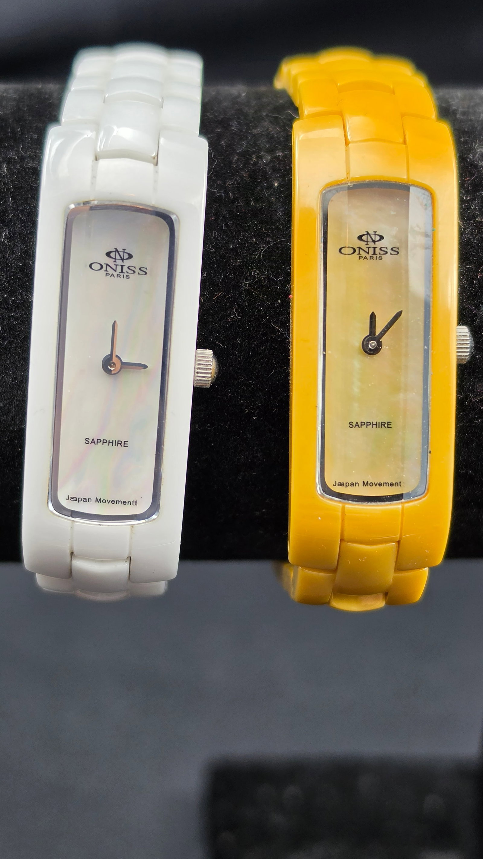 Lot of 2 Oniss Paris ceramic quartz ladies watches ON8045 sapphire crystal Japan movement white and: This is a matched pair of Oniss Paris quartz ladies wristwatches, model ON8045, offered together as a lot. Both watches feature high tech ceramic construction with sapphire crystal and 3ATM water resi