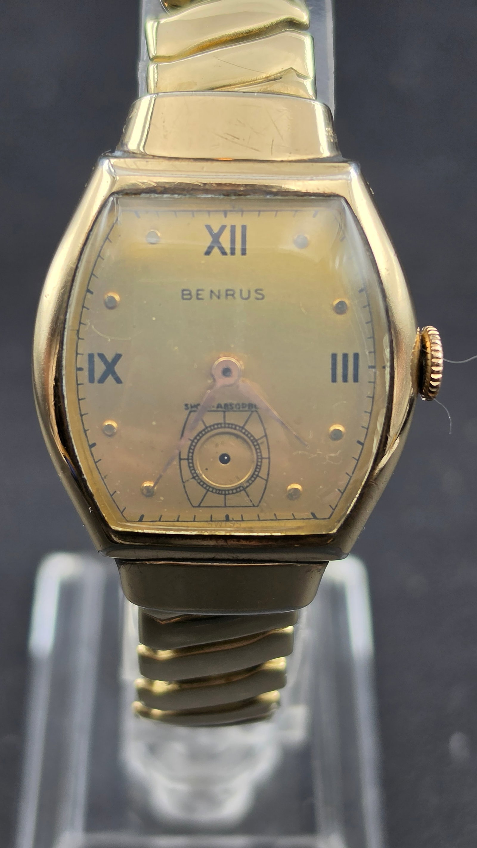 Benrus Shock-Absorber 17 Jewel Swiss Manual Wind Tonneau Watch 27.23mm Runs: Vintage Benrus manual wind tonneau shaped wristwatch measuring 27.23mm wide per digital calipers. The aged champagne dial features Roman numerals at 12, 9, and 3 o'clock with applied dot markers at th