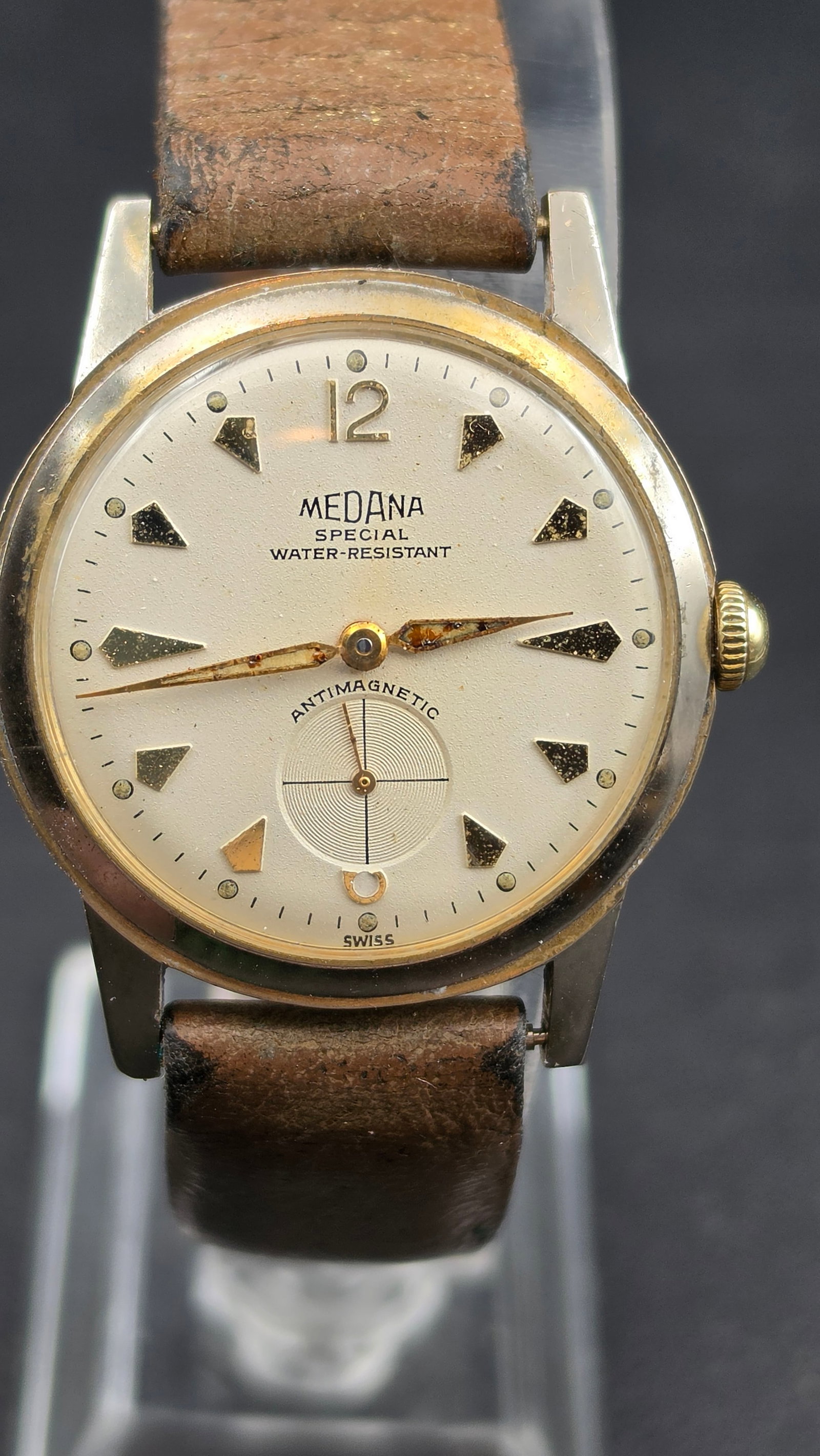 Medana Special Water Resistant Antimagnetic Swiss Watch Small Seconds 1 Jewel c.1950s 33mm: This is a vintage Medana Swiss manual wind wristwatch. The cream/silver dial features Medana printed in bold in the upper half, followed by Special and Water-Resistant printed below. Applied gold-tone