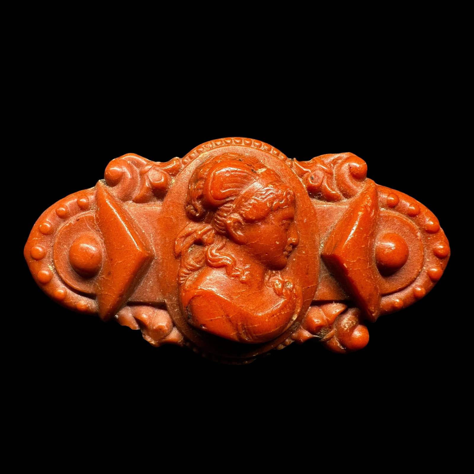 6g Antique Carved Coral Resin Cameo Brooch: 6g Antique Carved Coral Resin Cameo BroochBrand/Model: No hallmark.Manufacturer Location: Not marked.Year Produced: Unknown.Condition: Good antique condition with visible surface wear, minor chips, an