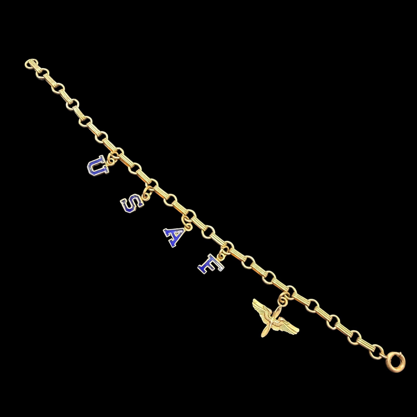Vintage WWII World War 2 Gold Tone USAF Military Pilot Charm Bracelet 7” Long: Maker: Unmarked. Material: Gold tone base metal. / Stone: None. Letters are enameled. / Size: 7” long. / Condition: Excellent, ready to wear and enjoy. / Sold as is. Measurements are approximate