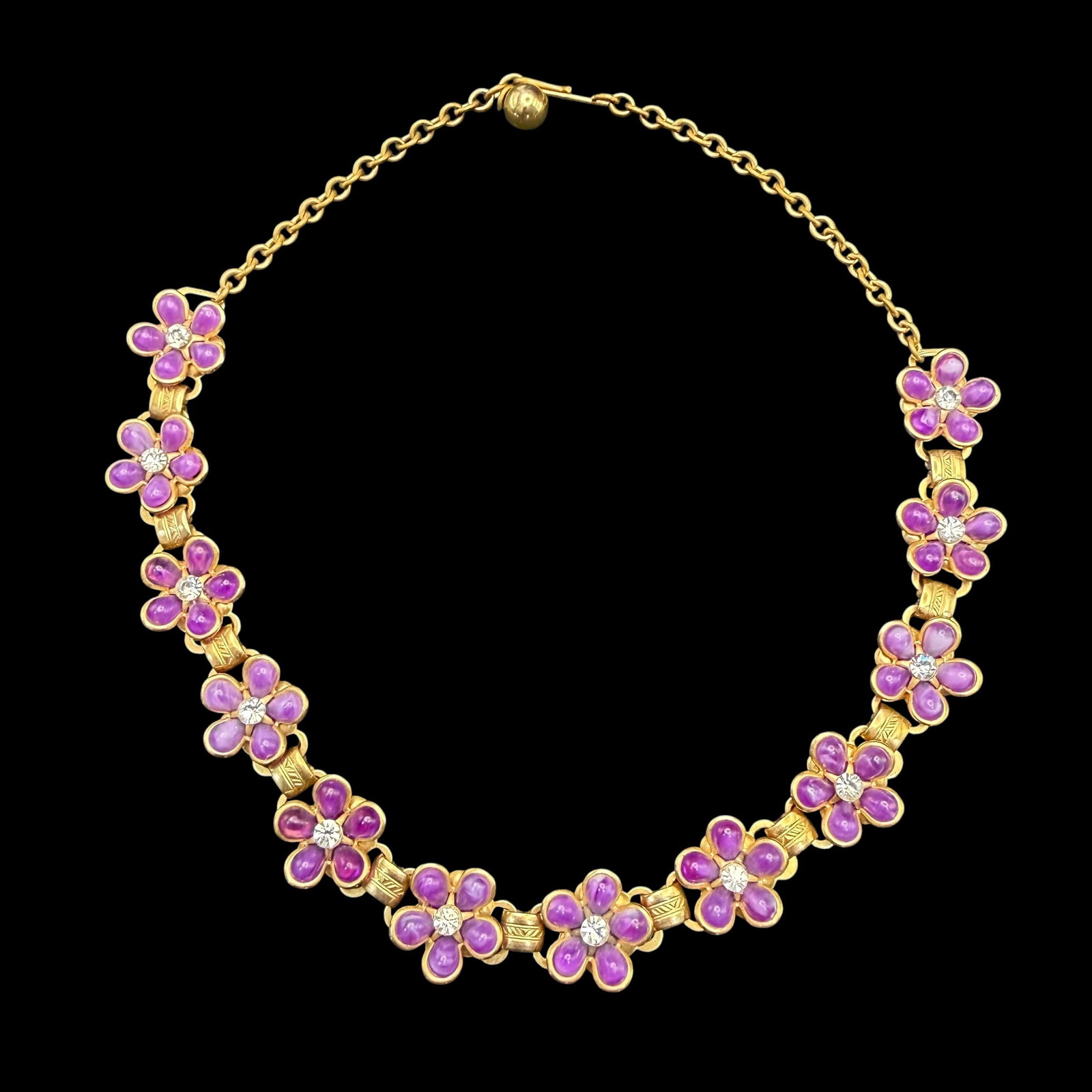 Vintage Gold Tone Purple Flower Rhinestone Chain Link Necklace Fancy Fashion Costume 16.25”: Maker: Unmarked, Unknown. / Material: Gold tone base metal. / Stone: The purple petals appear to be glass perhaps, the white centers Rhinestone I believe. / Size: 16 1/4” long overall. / Conditi