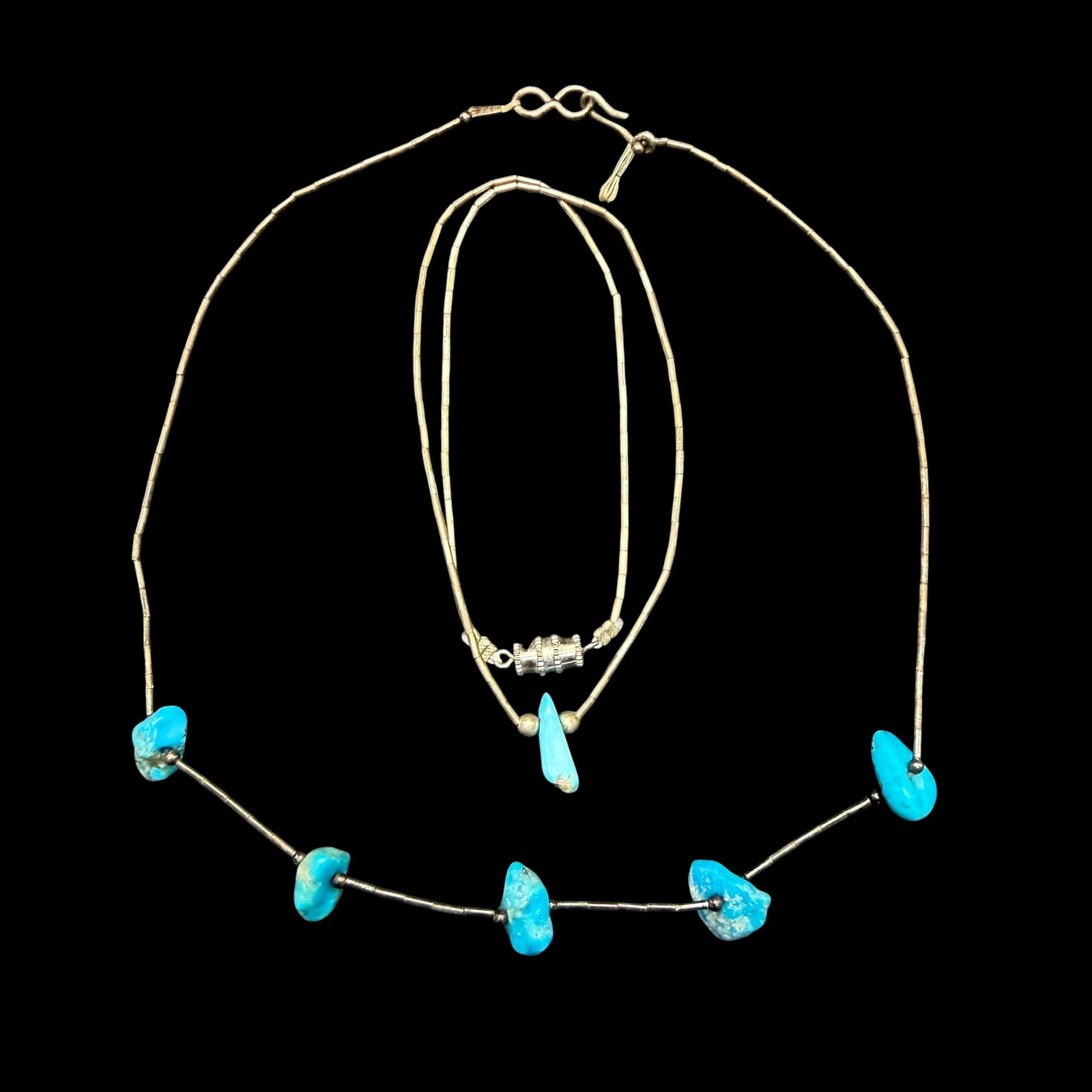 2 Vintage Native American Old Pawn Turquoise Liquid Sterling Silver Necklaces 15” 9.71g 925: Maker: Unmarked, likely Old Pawn on both. / Material: Sterling Silver. / Stone: Turquoise. / Size: 14 3/4” and 15” long. / Weight: 9.71 grams combined. / Condition: Excellent, ready to enj