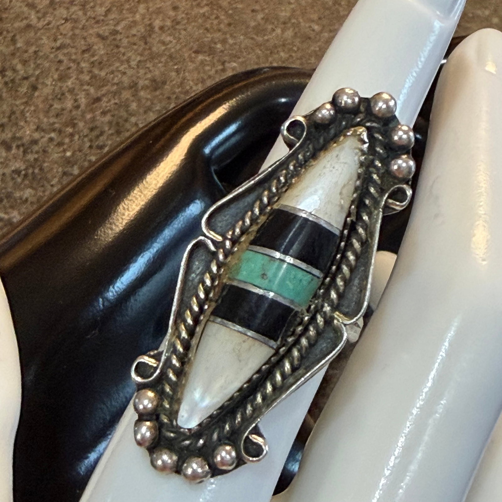 Vintage Sterling Silver Native American Turquoise MOP Onyx Ring Old Pawn Sz 6.75 8.93g 925: Maker: Unmarked, likely Old Pawn. / Material: Sterling Silver. / Stone: Mother of Pearl, Black Onyx, Turquoise. / Size: 6.75. Face measures 1 3/4” x 3/4”. / Weight: 8.93 grams. / Condition