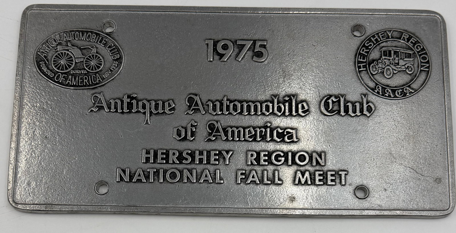 1975 AACA Hershey Region National Fall Meet Cast Aluminum Plaque: Vintage 1975 Antique Automobile Club of America (AACA) Hershey Region National Fall Meet commemorative plaque. Made of cast aluminum/metal with raised embossed lettering and antique automobile logos. 