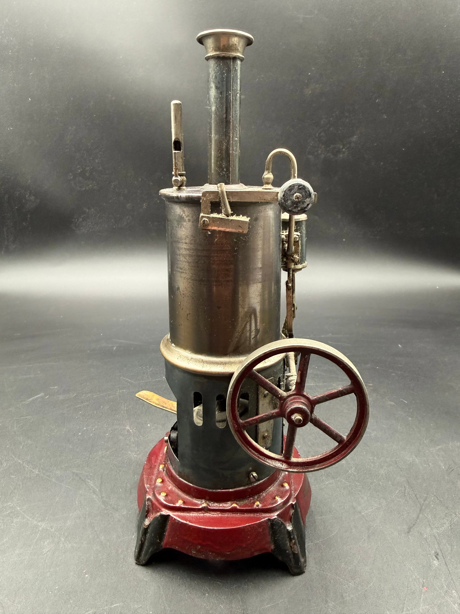 Antique Rare Version of German upright model steam engine: Antique Rare Version of German upright model steam engine. Appears to be complete with original paint. Flywheel and piston moves easy.