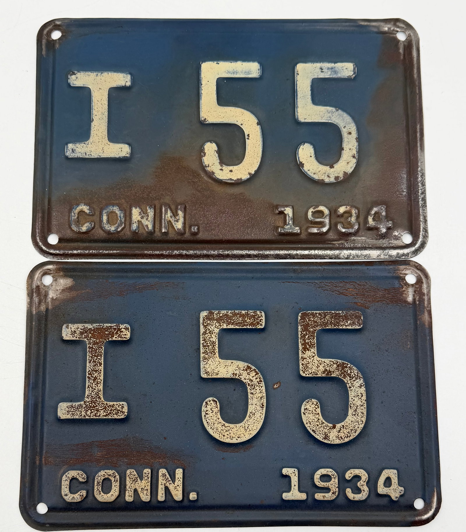 1934 Connecticut License Plate Pair I 55: Matching pair of original 1934 Connecticut license plates featuring embossed white lettering on dark blue steel backgrounds. Numbered “I 55” with “CONN. 1934” markings. Authentic vinta