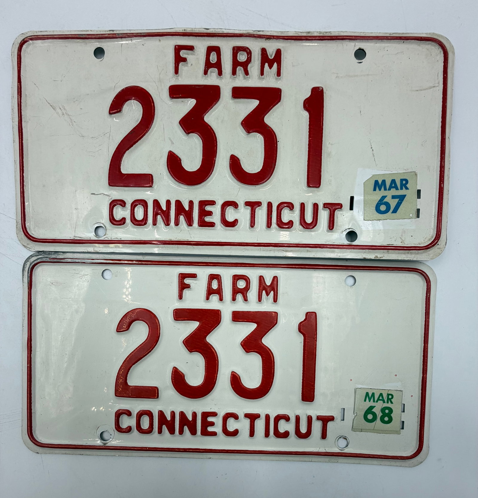1967 & 1968 Connecticut Farm License Plate Pair #2331: Original matched pair of Connecticut FARM license plates numbered 2331 with 1967 and 1968 March validation tabs. White background with red embossed lettering. Includes both front and back views shown.