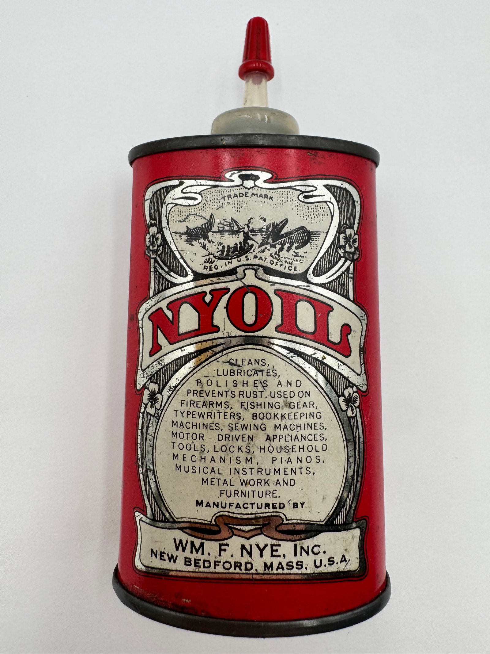 Vintage NYOIL Household Lubricating Oil Tin Can Wm F Nye: Vintage NYOIL lubricating oil tin can manufactured by Wm. F. Nye, Inc. of New Bedford, Massachusetts. This colorful red advertising oil can features ornate early industrial graphics and retains its or