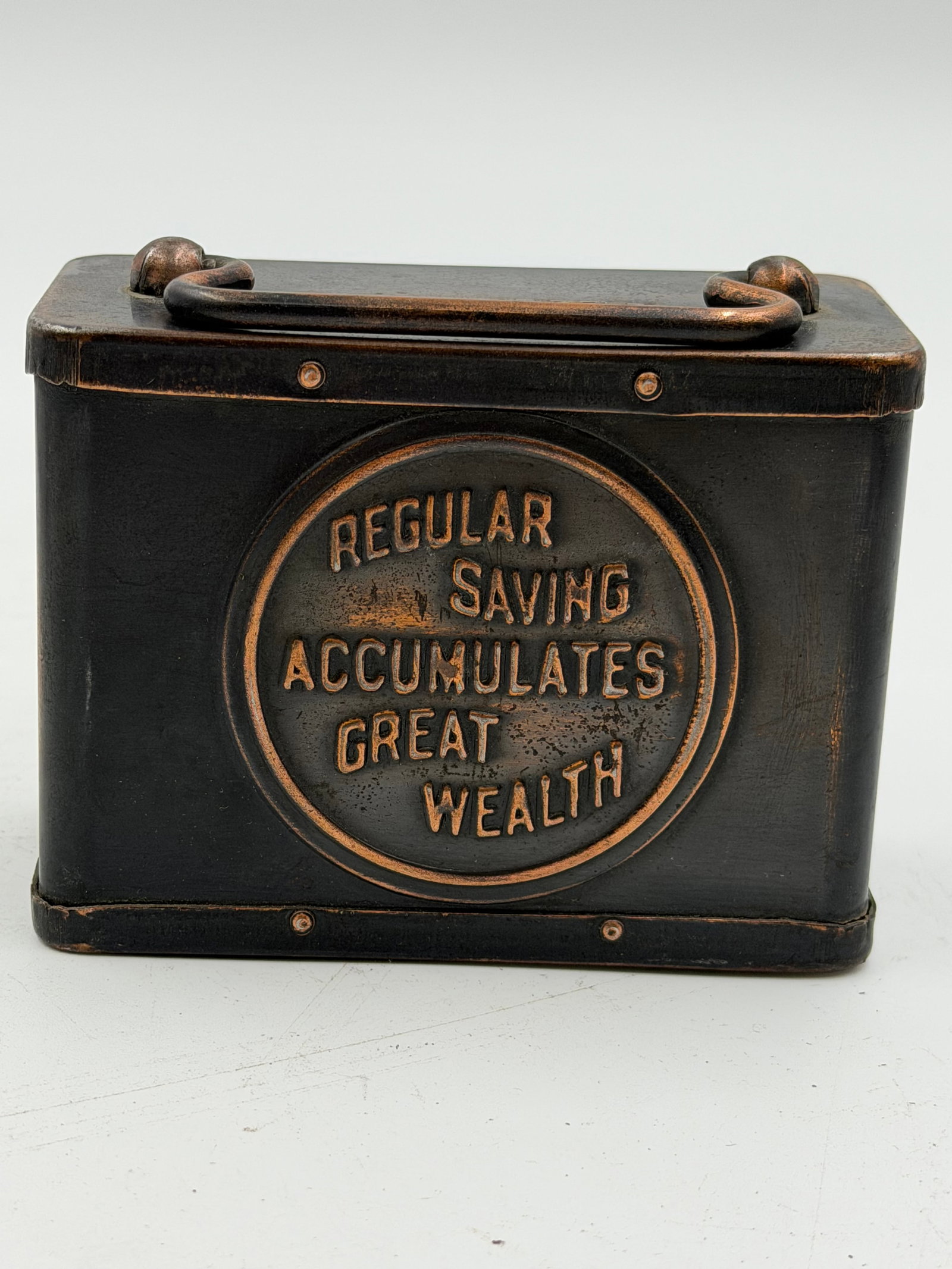 Antique Bank of Northfield Coin Bank Safe Box: Vintage metal coin savings bank marked “Bank of Northfield” with embossed slogan “Regular Saving Accumulates Great Wealth.” Features original carry handle, coin slot top, working lock 