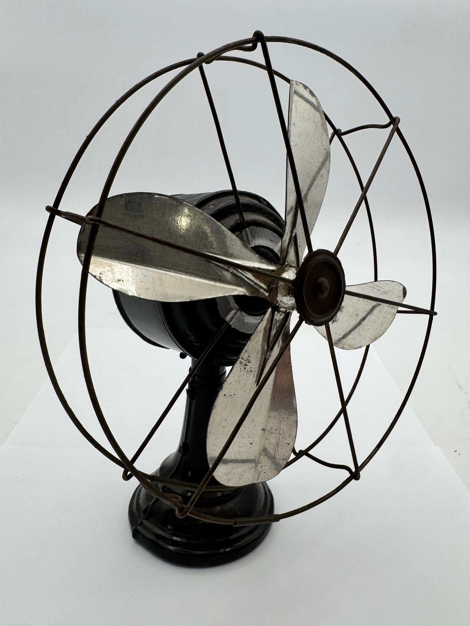 German tin windup fan: Antique German tin windup fans are rare mechanical devices primarily produced in the late 19th and early 20th centuries,