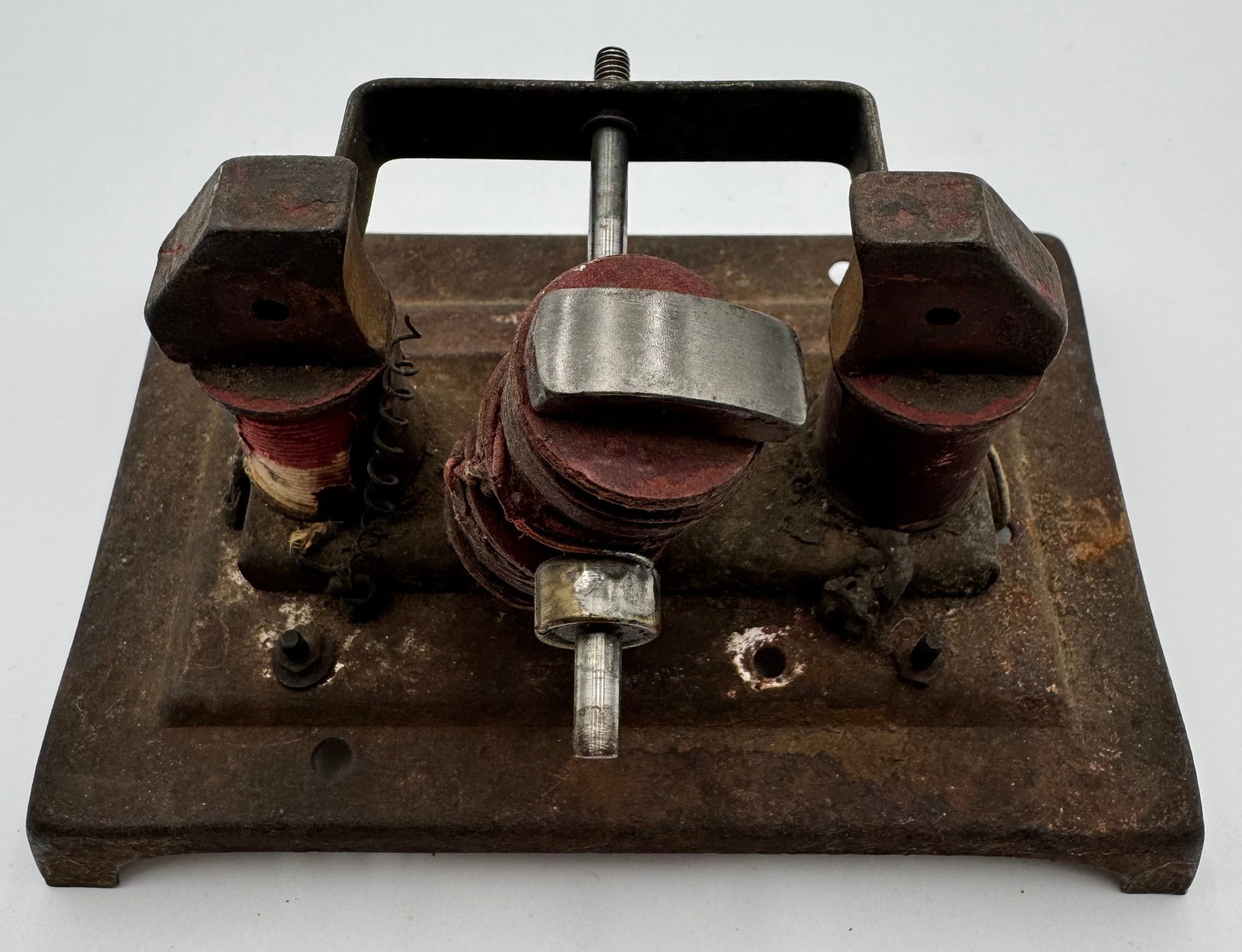 Antique Electromagnetic Motor Scientific Apparatus: Antique electromagnetic laboratory apparatus featuring cloth-wrapped coils, iron magnetic arms, rotating shaft assembly, and heavy cast iron base. Likely used as an early electric motor or scientific