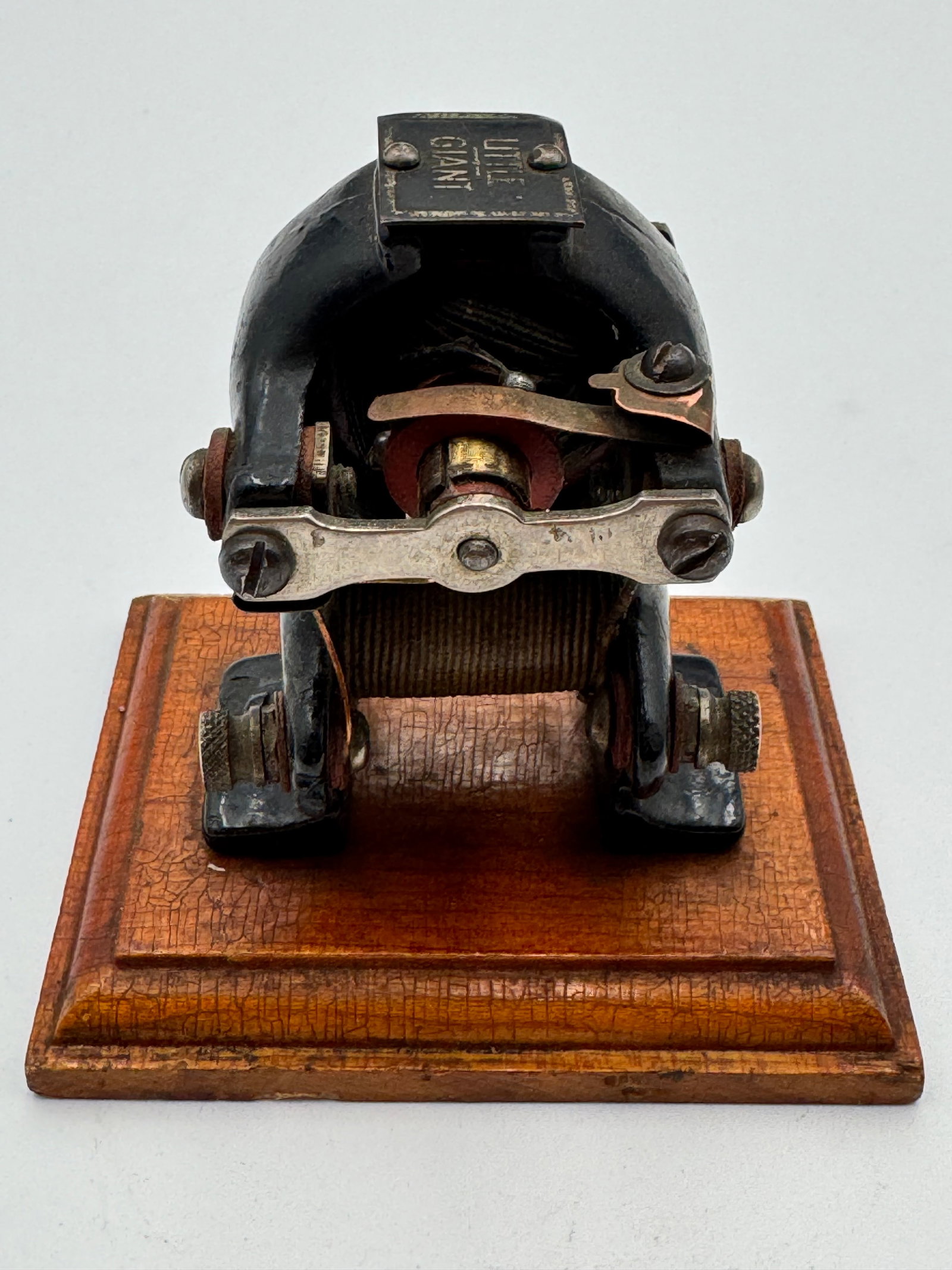 Antique LITTLE GIANT Electromagnetic Motor Scientific Instrument: Rare antique “LITTLE GIANT” toy electric motor dating to the early 1900s, featuring a cast iron housing mounted on its original wood base. This early electromagnetic motor includes original co