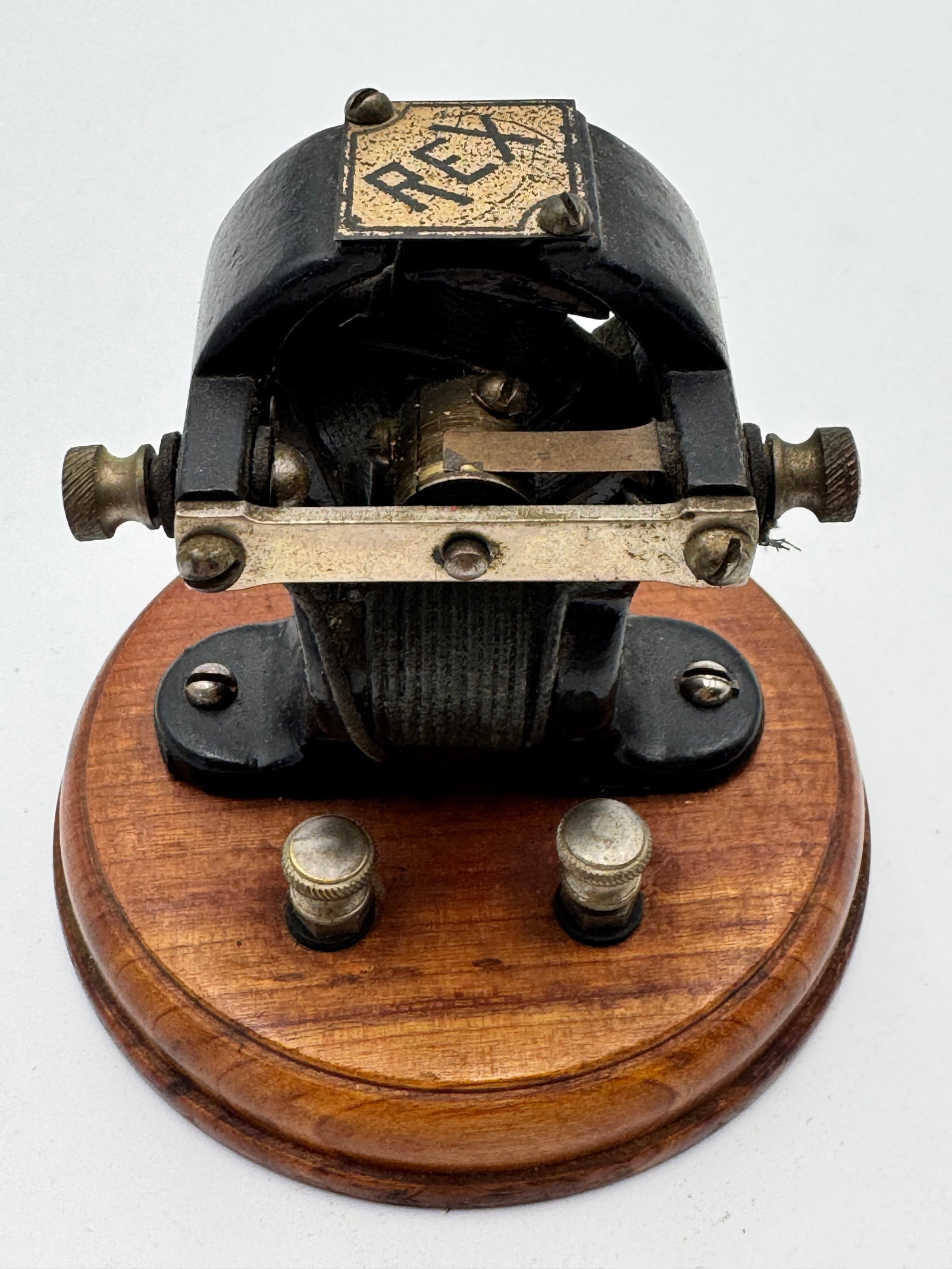 Antique REX Electric Motor Early Scientific Demonstrator c.1900: Rare antique “REX” demonstration electric motor dating to the early 1900s, featuring a cast iron housing mounted on a round wooden base. This early electromagnetic motor includes original