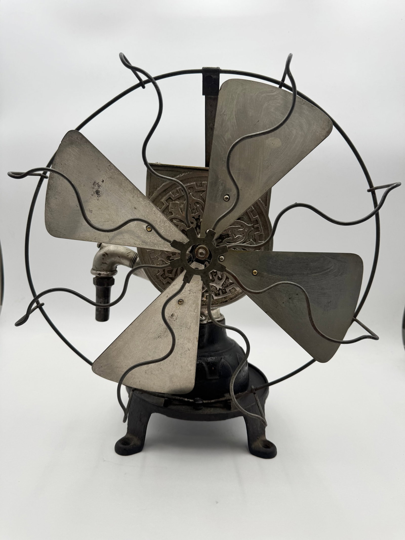 Indiana Water Powered 12” Fan: Authentic antique Indiana Fan Co. water powered manufactured in Indianapolis, Indiana. Features original cast iron construction, four metal blades,safety cage, and ornate rear motor housing. Classic e