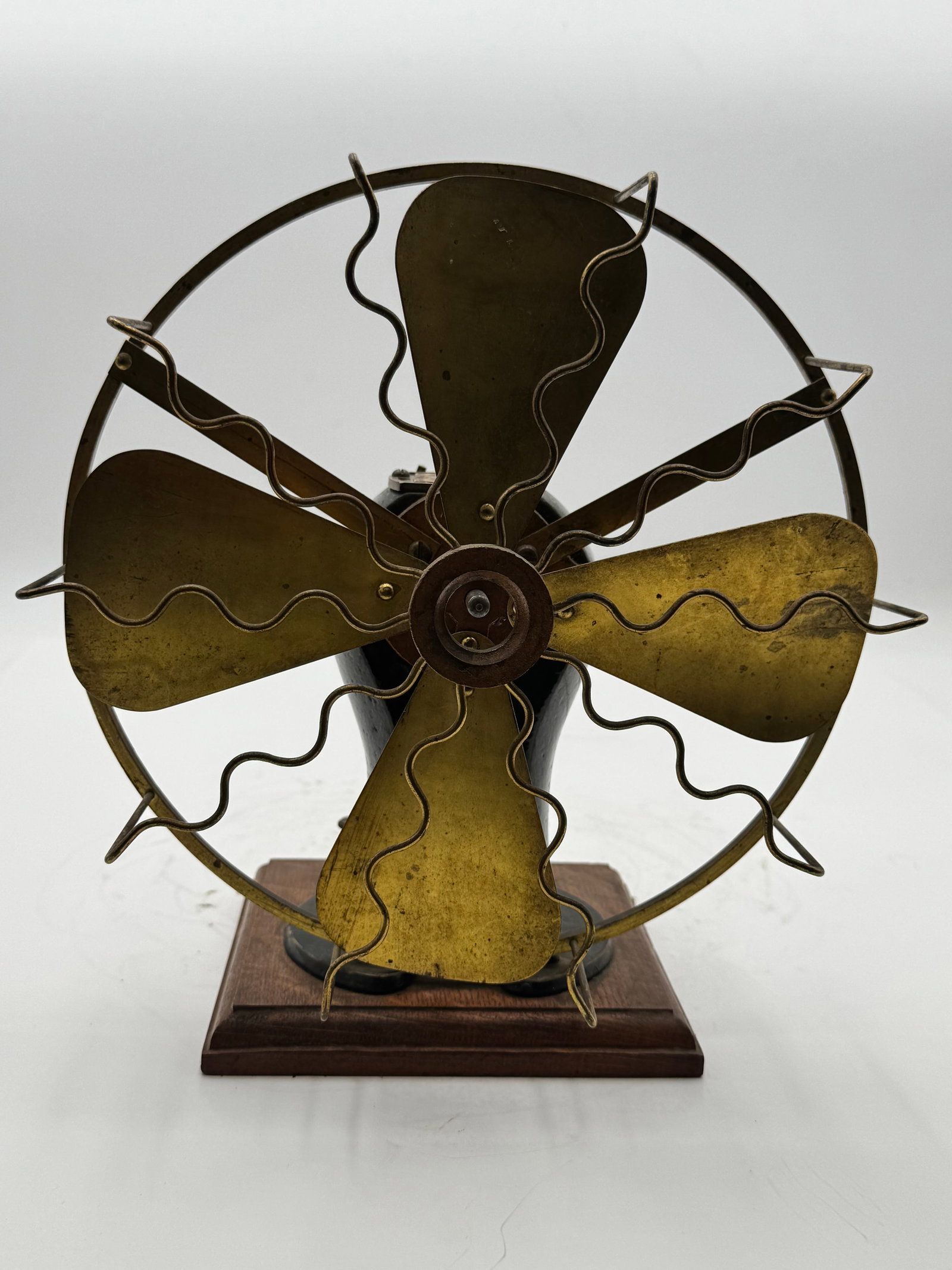 Antique Manhattan No. 3 Electric Fan Brass Blade Desk Fan: Antique Manhattan No. 3 electric fan featuring four original brass blades, an ornate wavy wire guard, and a beautifully cast black motor housing with raised “Manhattan No. 3 Motor” badge.This 