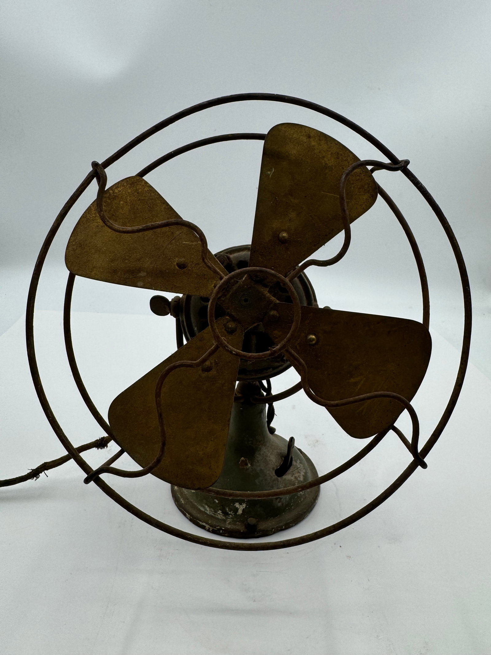 Fidelity Electric 8” Fan Lancaster Pennsylvania: Antique Holtzer Electric Company desk fan from Lancaster, Pennsylvania featuring four brass blades, early wire cage guard, and heavy cast iron base with traces of original green finish. Marked “Holt