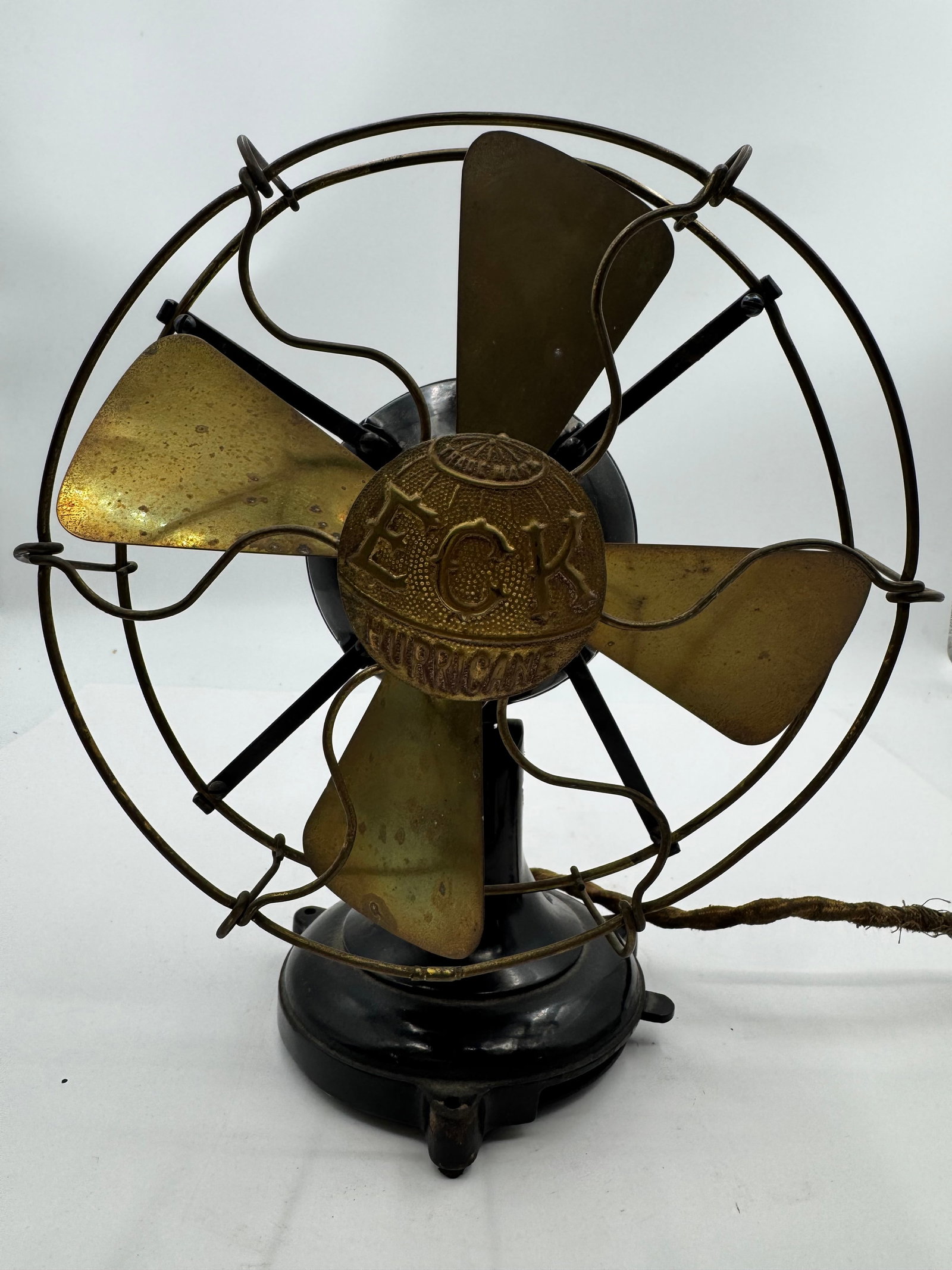 Antique ECK 8’’Hurricane Brass Blade Electric Desk Fan Belleville NJ: Antique ECK Hurricane electric desk fan manufactured by ECK Dynamo & Motor Co., Belleville, New Jersey. Features four brass blades, ornate brass wire cage, and black cast iron base with original “Hu
