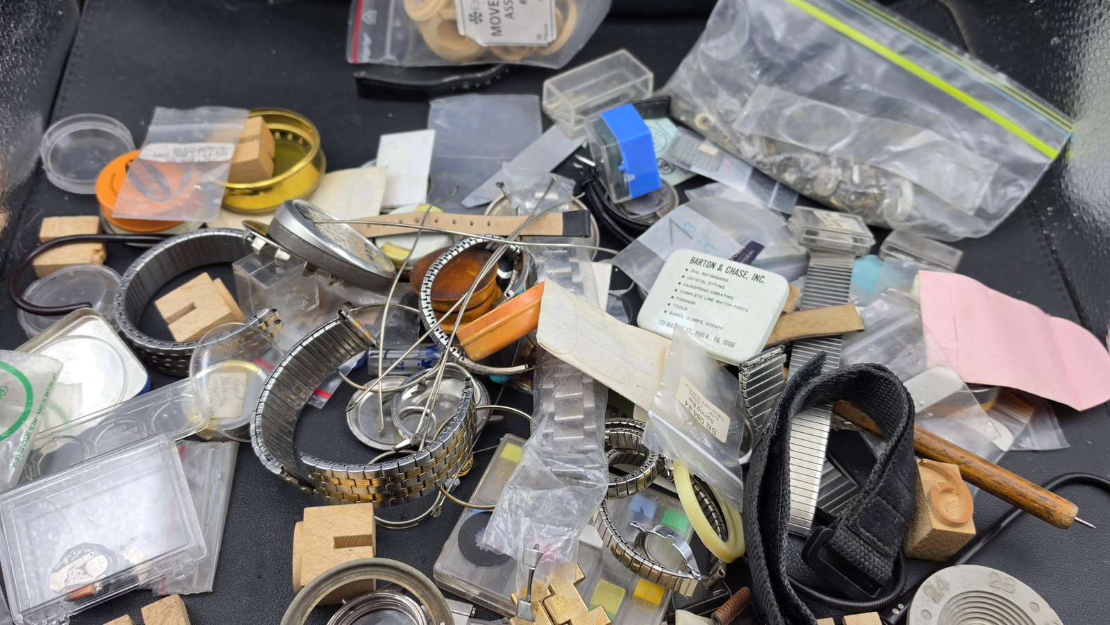 Vintage Watchmaker Parts Supply Lot Crystals Bands Cases Tools Esslinger Barton Chase NOS: This is a substantial vintage watchmaker's parts and supply lot ideal for the hobbyist watchmaker, repair technician, or collector. The lot includes an Esslinger and Co. Movement Ring Assortment #MR 3