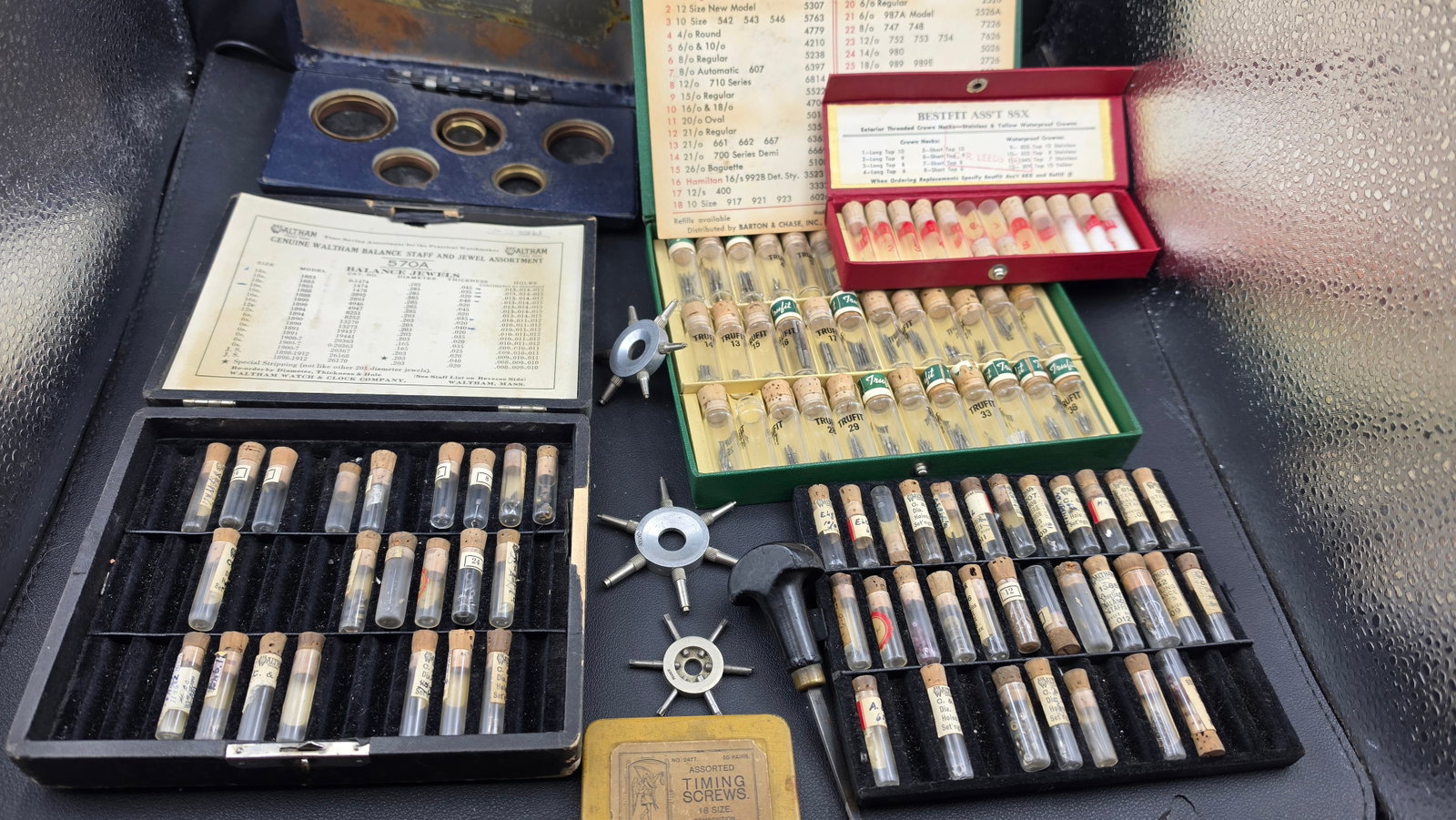 Vintage Watchmaker's Supply Collection — Waltham Balance Staff & Jewel Assortment, Trufit Crowns,: This is an exceptionally complete and well-preserved vintage watchmaker's bench supply collection representing decades of professional horological parts accumulation. The centerpiece is a genuine Walt