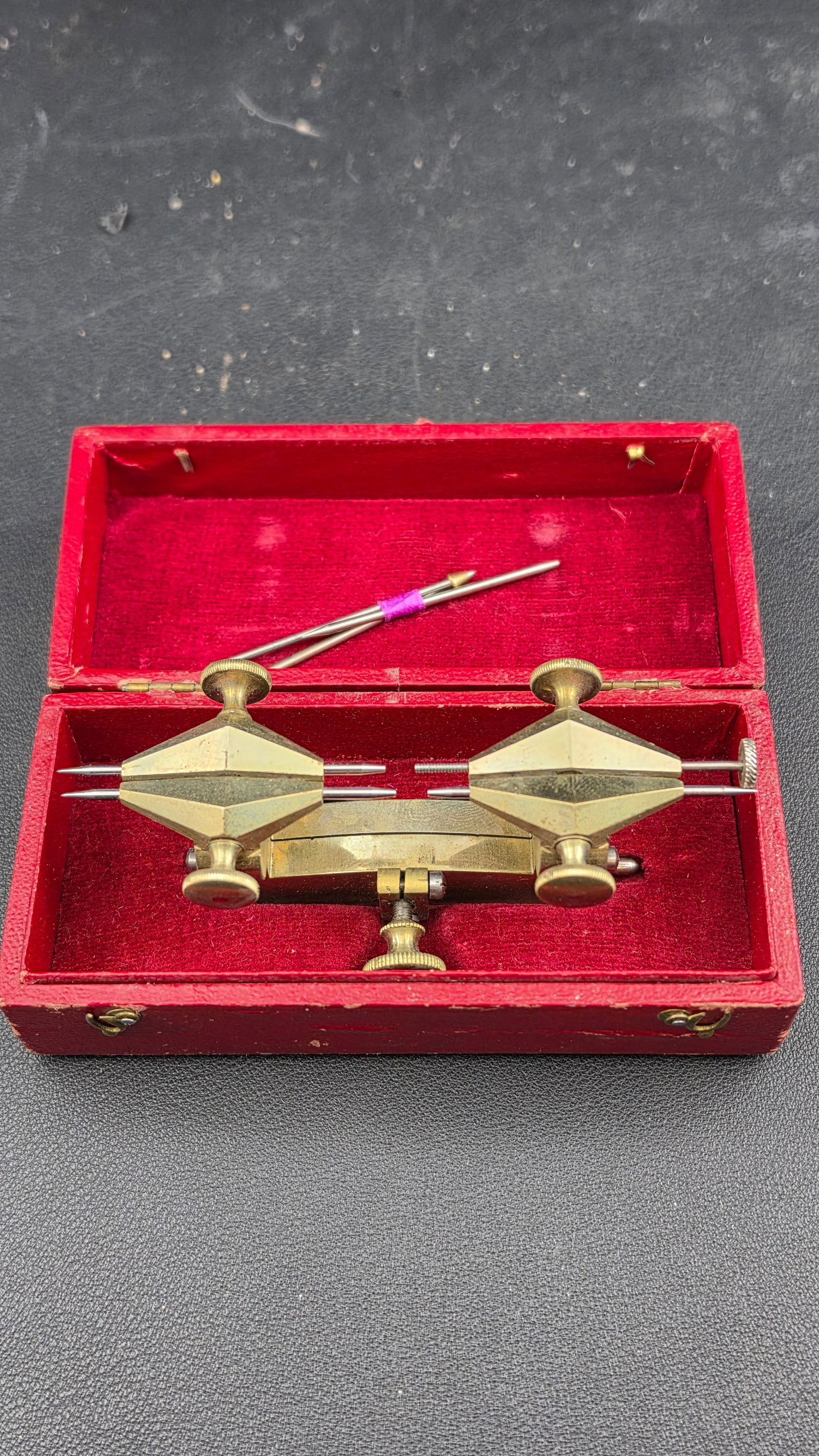 Antique Swiss Watchmaker's Brass Depthing Tool "Compas 26 Lignes" in Original Red Case c. Late: A complete and well-preserved Swiss watchmaker's brass depthing tool in its original red leatherette hinged presentation case, the lid stamped in gold "COMPAS 26 LIGNES." The depthing tool — also ca