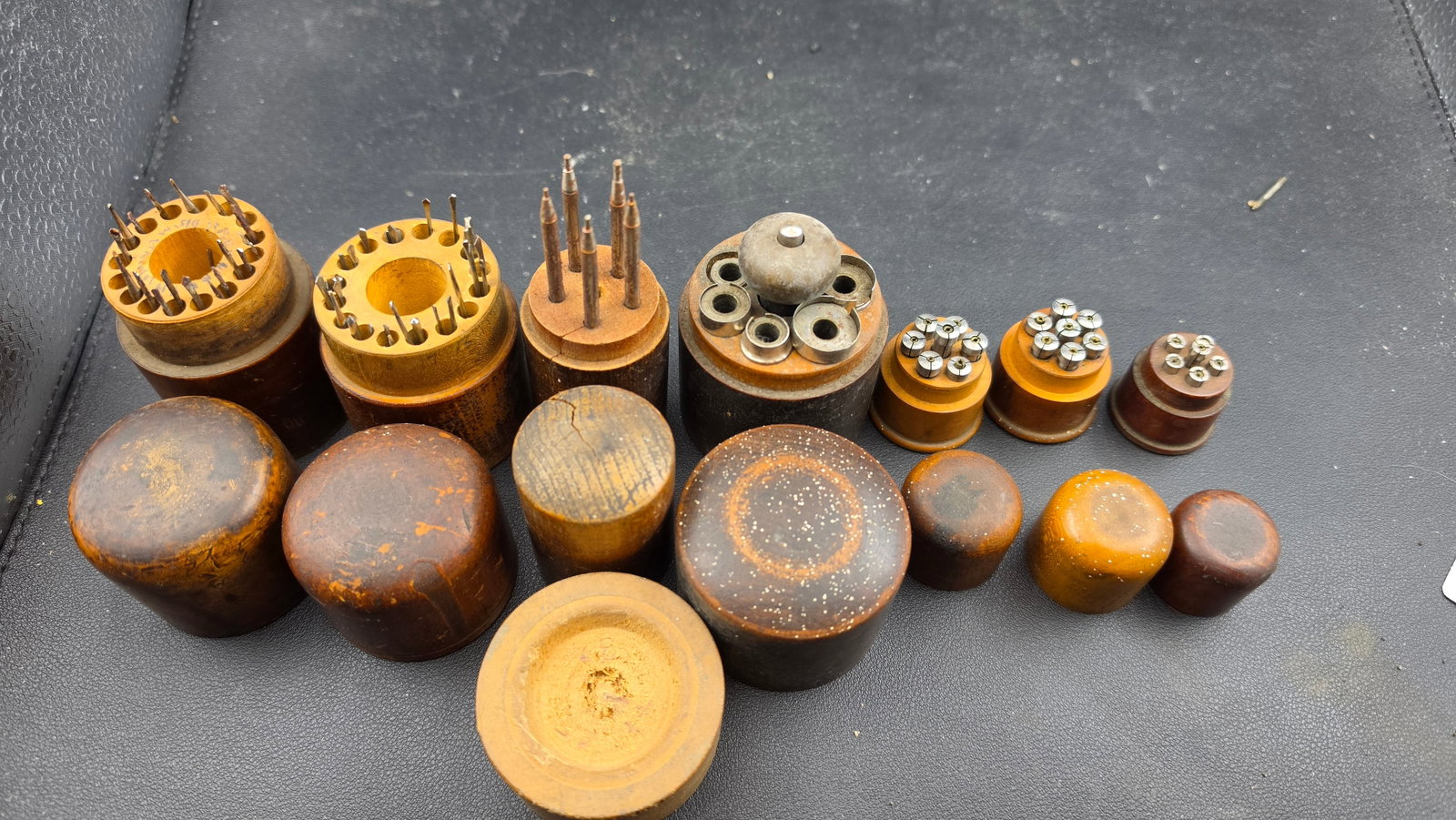Lot 7 Vintage Watchmaker WW Lathe Wood Storage Blocks Collets Gravers Drills ca. 1920s-1950s: This is a lot of seven vintage turned wooden cylinder storage blocks of the type used on the watchmaker's bench to organize and store accessories for the WW-pattern watchmaker's lathe. The blocks rang