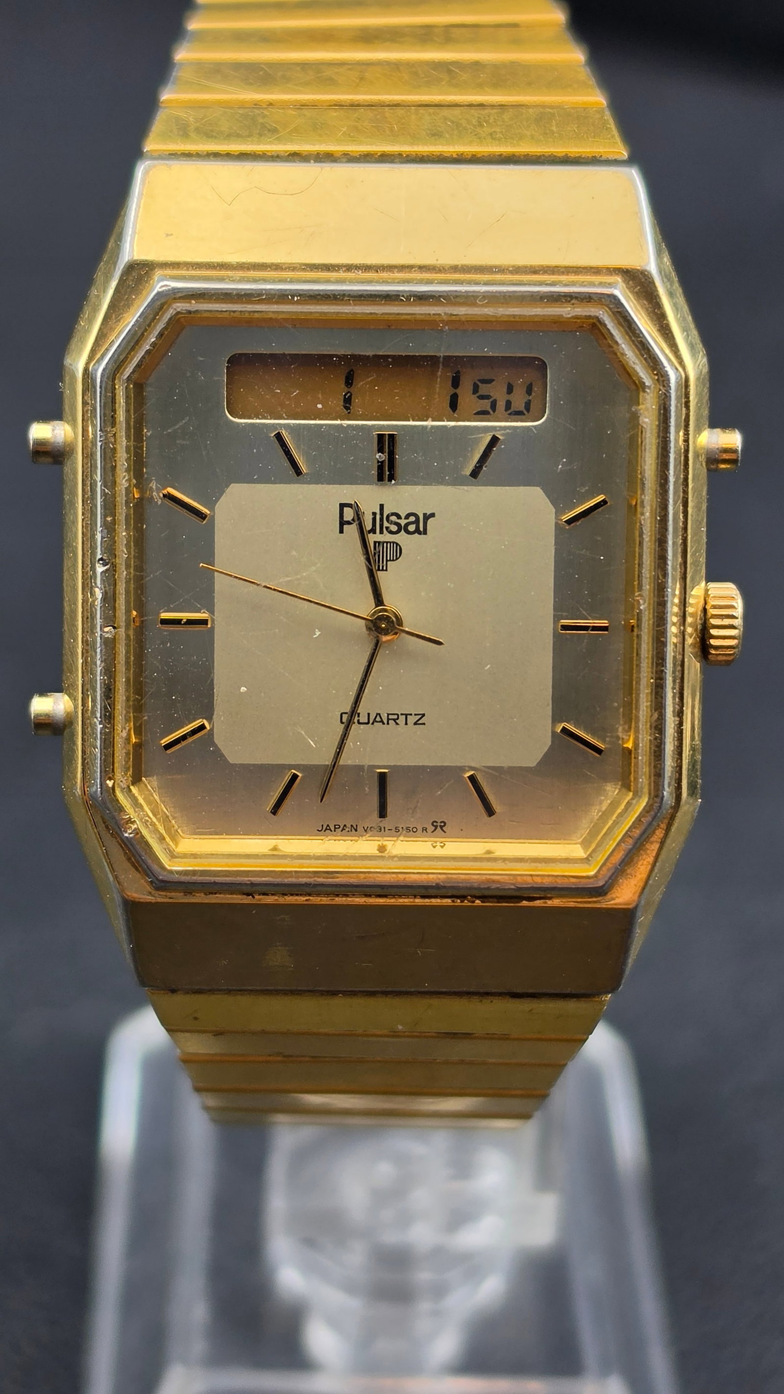 Pulsar by Seiko Ana-Digi Quartz Watch Gold Tone Octagonal Case V031-5080 Japan c. 1980s Running: This is a vintage Pulsar by Seiko analog-digital quartz watch, reference V031-5080, made in Japan and dating to the mid-1980s. The case back is stamped Pulsar / Water Resistant / Base Metal Bezel / St