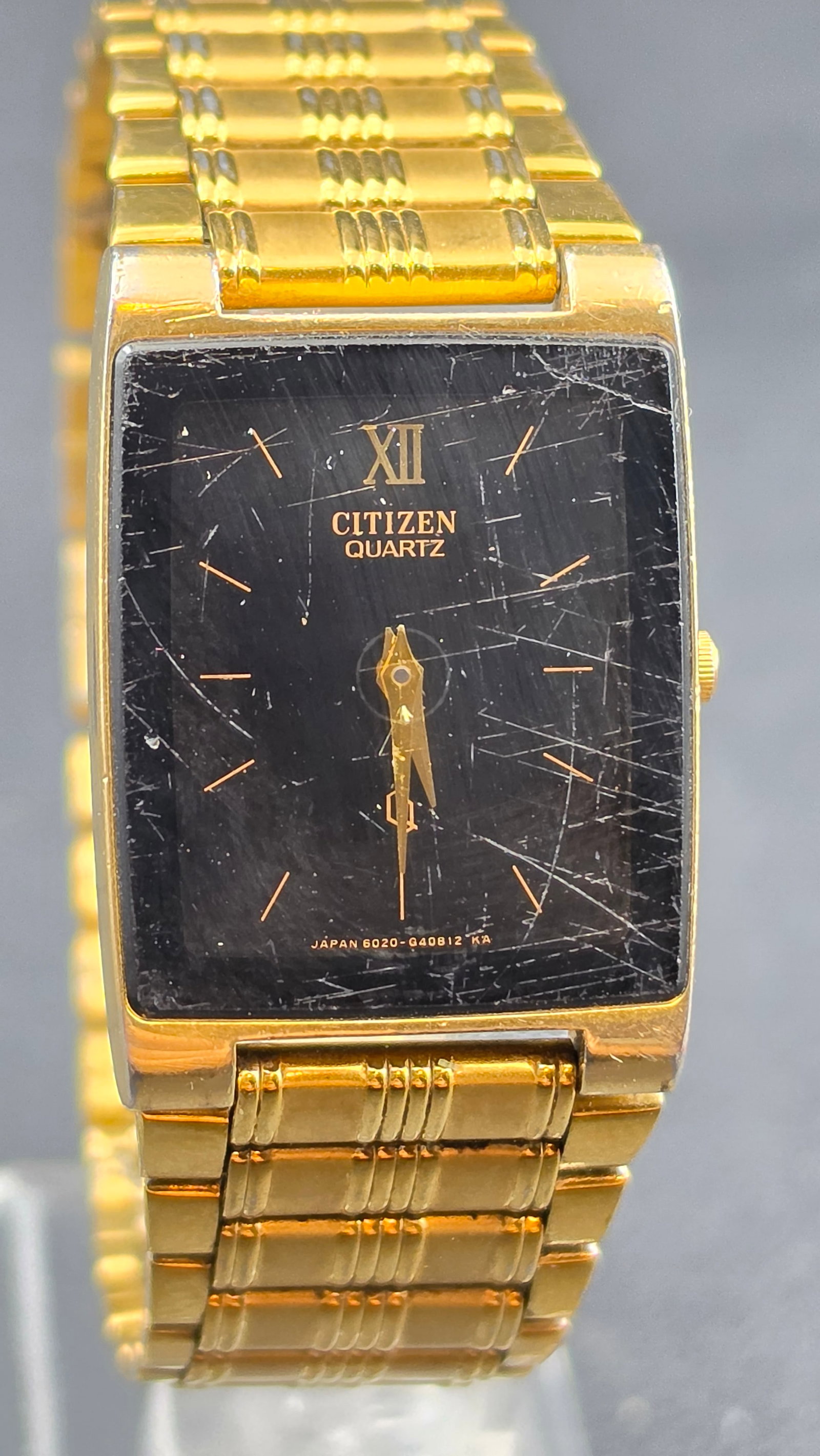 Citizen Quartz Tank Style Gold Tone Black Dial Dress Watch Cal. 1020 Ref H14231 Japan c. 1980s: This is a vintage Citizen quartz dress watch in a slim rectangular tank-style case, reference 1020-H14231 TA, powered by Citizen caliber 1020 and made in Japan in the early 1980s per the GN-0-S design