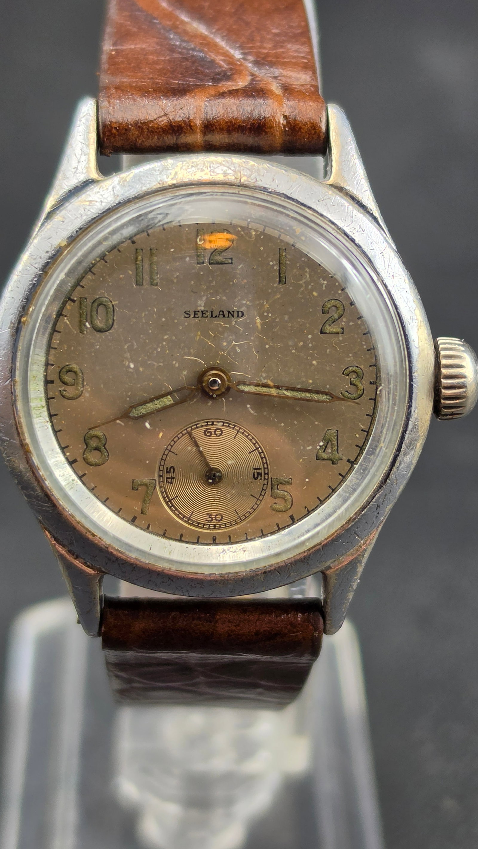 Seeland Watch Co Swiss 7 Jewel Manual Wind Military Style Tropical Dial Keystone Case c. 1940s: This is a vintage Seeland Watch Company manual wind wristwatch dating to the 1940s, powered by a Swiss 7-jewel movement signed "Seeland Watch Co. / Seven 7 Jewels / Swiss Unadjusted," housed in a Keys