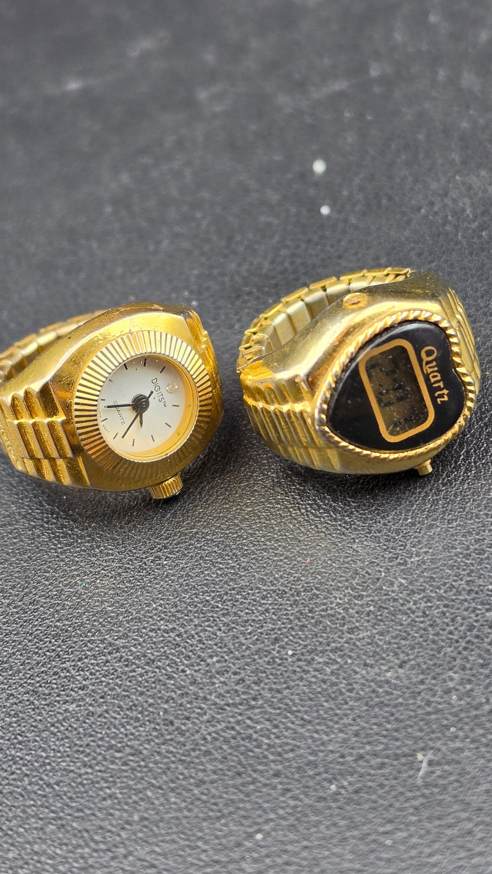 Lot of 2 Vintage Gold-Tone Finger Ring Watches Digits Analog LCD Digital Quartz Novelty 1980s: This lot consists of two vintage gold-tone finger ring watches from the 1980s novelty watch era, sold together as a pair. The first is a Digits brand analog quartz ring watch with a small round white 