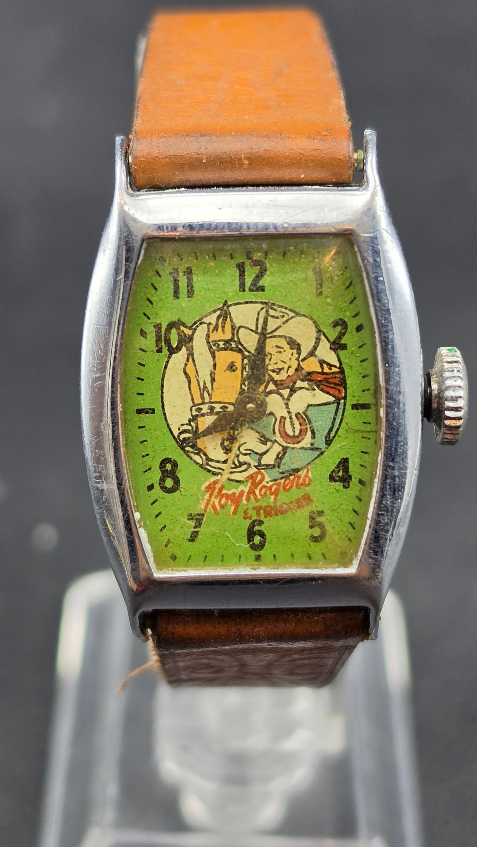Vintage Roy Rogers and Trigger Children's Character Watch Chrome Plated Tonneau Case Leather Strap 1: This is a vintage Roy Rogers and Trigger children's character wristwatch in a chrome-plated tonneau case measuring approximately 24mm across, with Chrome Plated stamped on the case back. The green dia