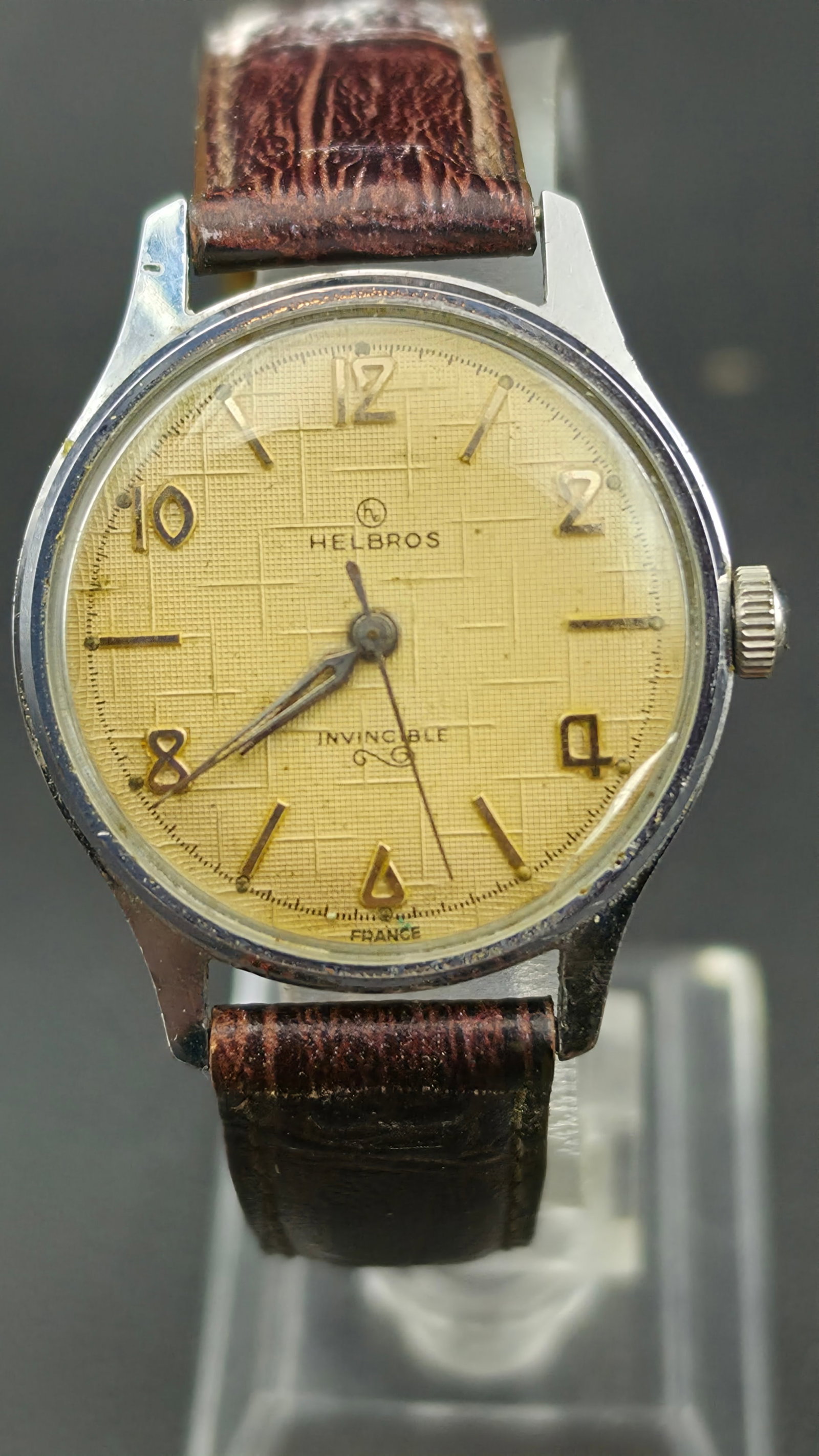 Helbros Invincible France Men's Manual Wind Mechanical Watch c.1950s Textured Dial 33mm Stainless Ba: Helbros was a Swiss-American import brand that supplied the mid-century U.S. market with well-made mechanical watches at accessible price points, frequently sourcing movements and cases from French an