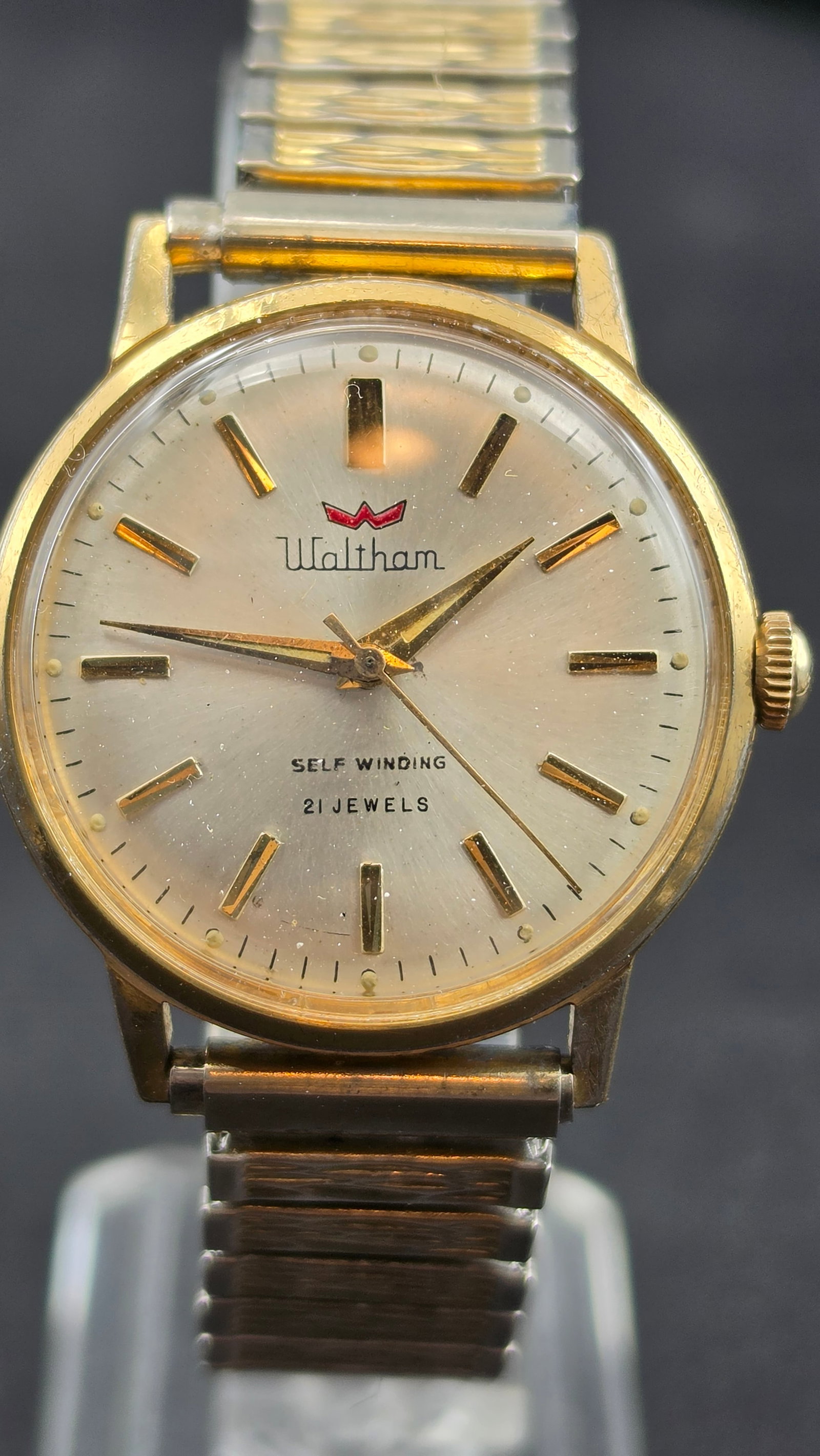 Vintage Waltham Self Winding 21 Jewels Men's Automatic Watch c.1960s Gold-Tone 34mm Expansion Bracel: This is a late-era example from the Waltham name's post-original-company period, bearing the distinctive red crown "W" logo that Waltham adopted in its final production years and through its successor