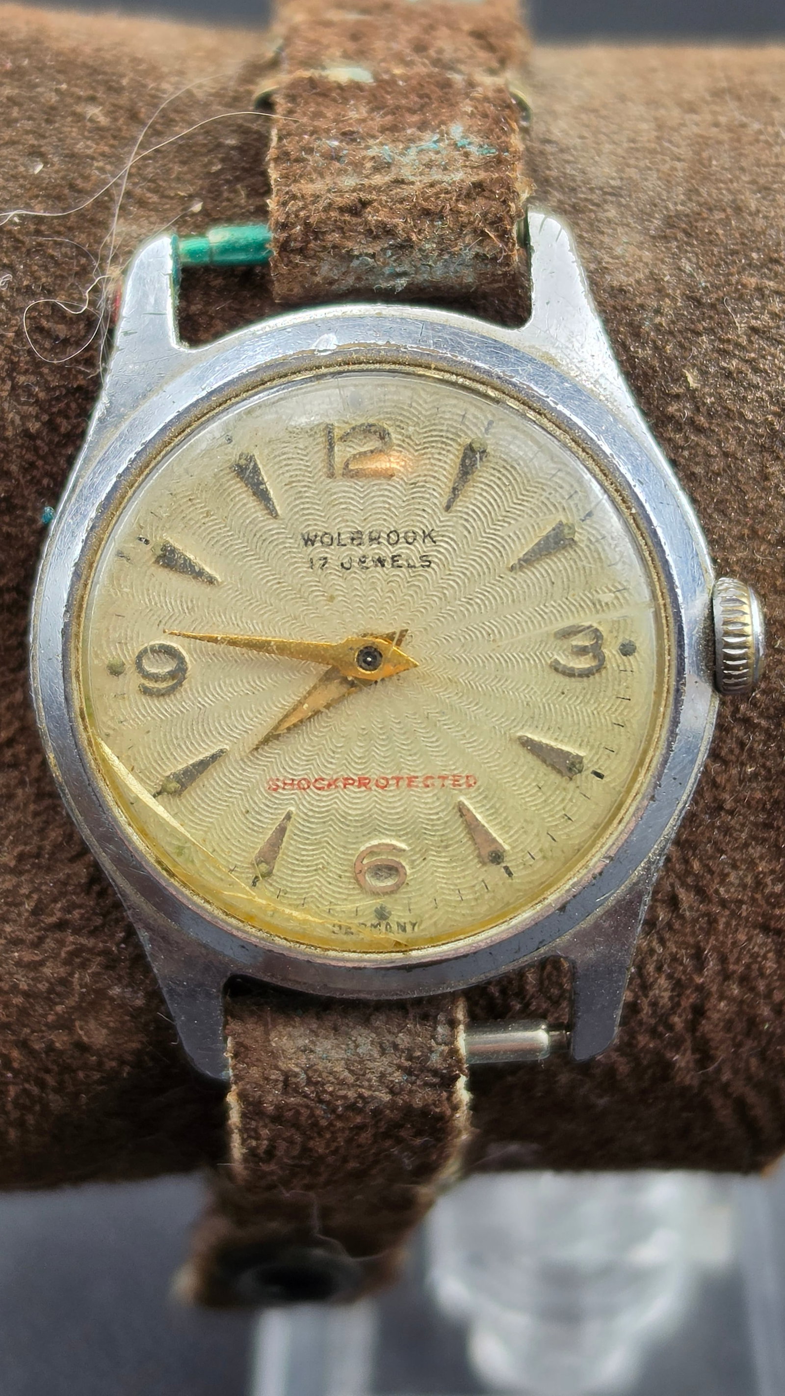 Vintage 1950s Wolbrook 17 Jewel Shockprotected Germany Manual Wind Watch 31mm Cuff Strap: Up for sale is a vintage Wolbrook manual-wind wristwatch dating to the 1950s. The round chrome-tone case measures approximately 31mm wide and presents a cream guilloche-patterned dial with applied arr