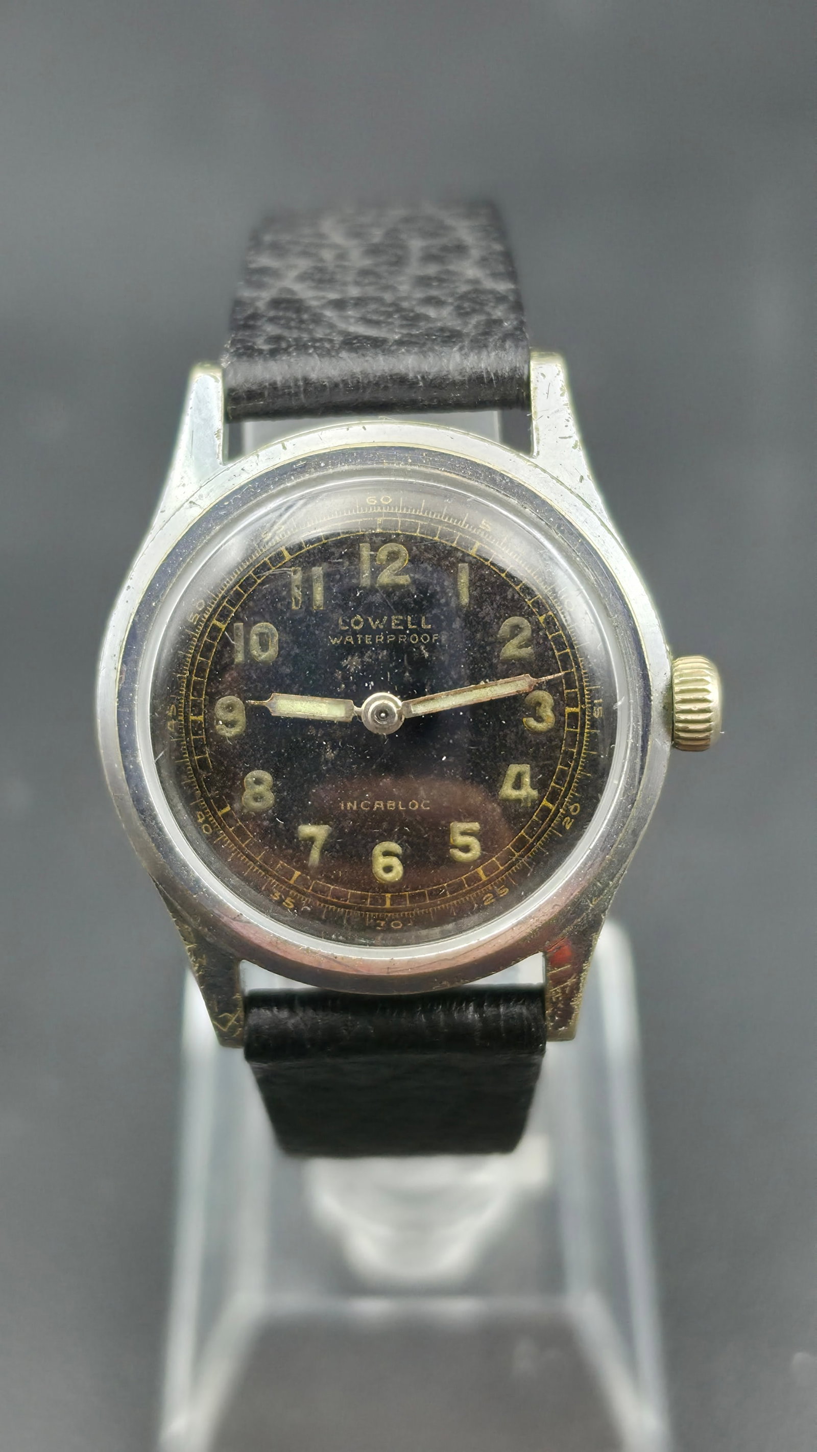 Vintage 1940s-50s Lowell Waterproof Incabloc Black Dial Swiss Field Watch Enicar 17J 31mm Runs: Up for sale is a vintage Swiss manual-wind field watch dating to the late 1940s or early 1950s, marked "Lowell / Waterproof / Incabloc" on the dial — a private-label name cased with an Enicar Watch 
