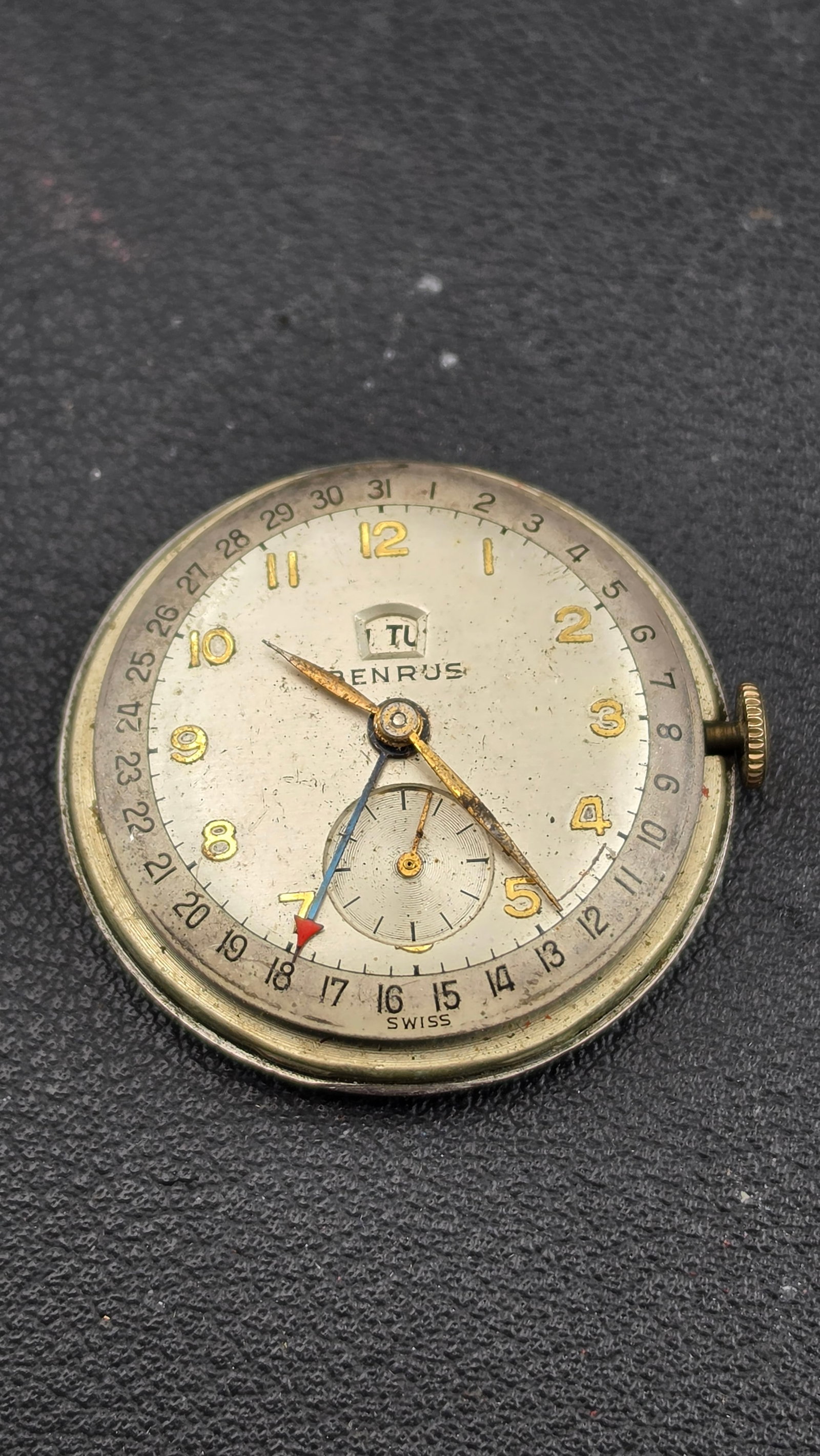 1950s Benrus Triple Calendar Day Date Pointer Movement & Back Model CE 45 17 Jewel Runs Swiss: Up for sale is a vintage Benrus triple calendar day-date pointer movement with its original stainless steel case back, removed from the outer case. The silvered dial presents gold Arabic numerals, a p