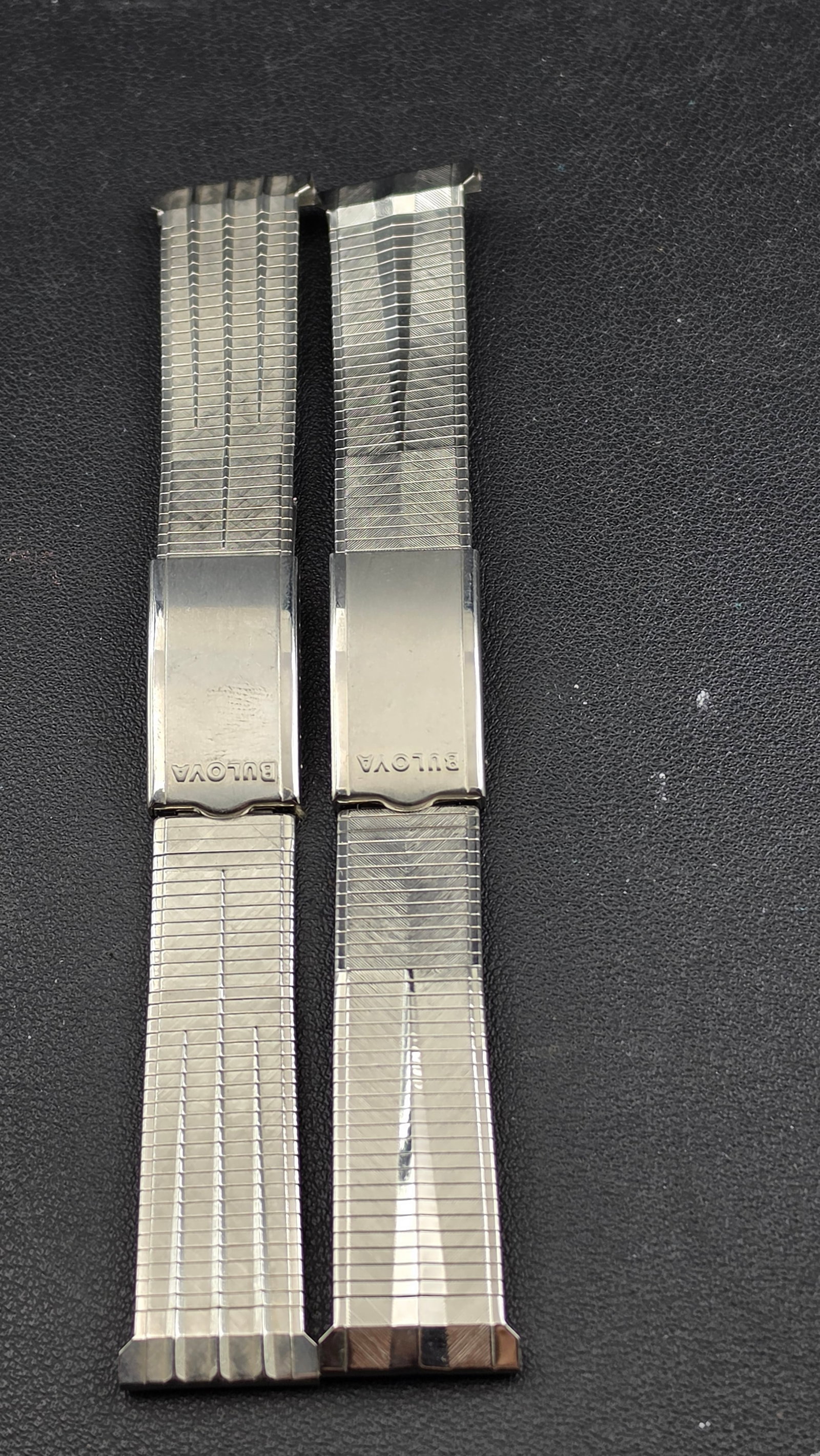Lot of 2 Vintage Duchess Stainless Steel Watch Bracelets Bulova Clasp 19-20mm: Up for sale is a pair of vintage Duchess brand stainless steel watch bracelets, each featuring a Bulova-signed fold-over clasp. The first is a flex expansion style with a textured crosshatch and diago