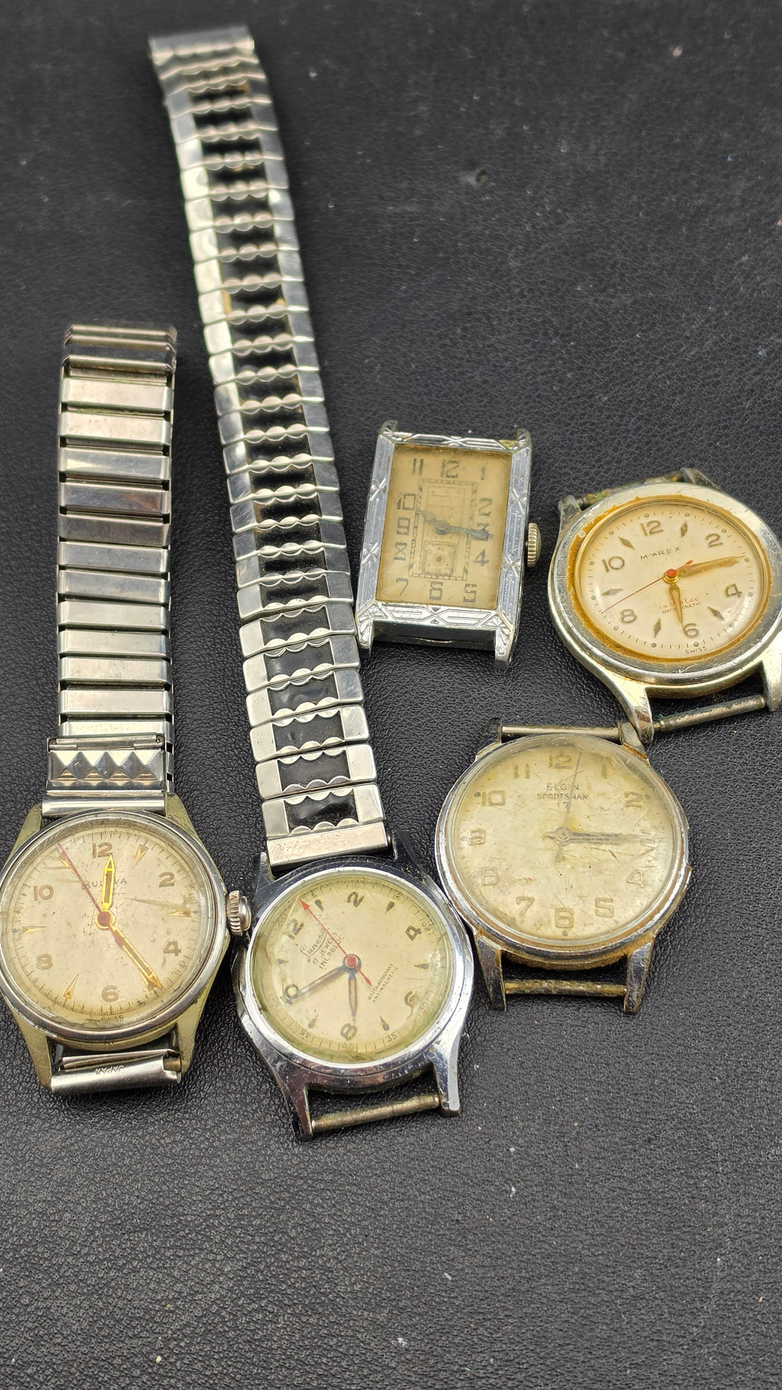 Lot of 5 Vintage Swiss & American Manual Wind Watches 1920s–1950s Parts Repair: Up for sale is a lot of five vintage men's manual-wind watches spanning the 1920s through the 1950s, offered for parts, repair, or display. The lot includes a 1953 Bulova (case back coded "L3" with se