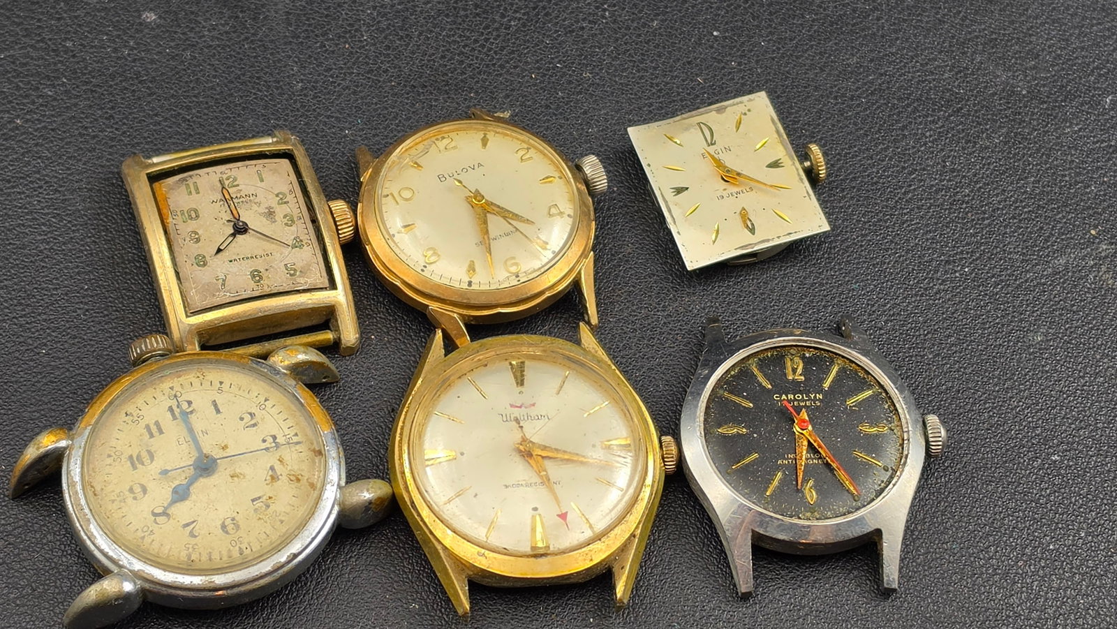 Lot of 6 Vintage Watches Elgin WWI Wire Lug Bulova Waltham Wakmann Carolyn Parts 1920s–1960s: Up for sale is a lot of six vintage watches offered for parts, repair, or display. The standout piece is an early Elgin with a wire/tortoise-shell lug case characteristic of the WWI and early 1920s er