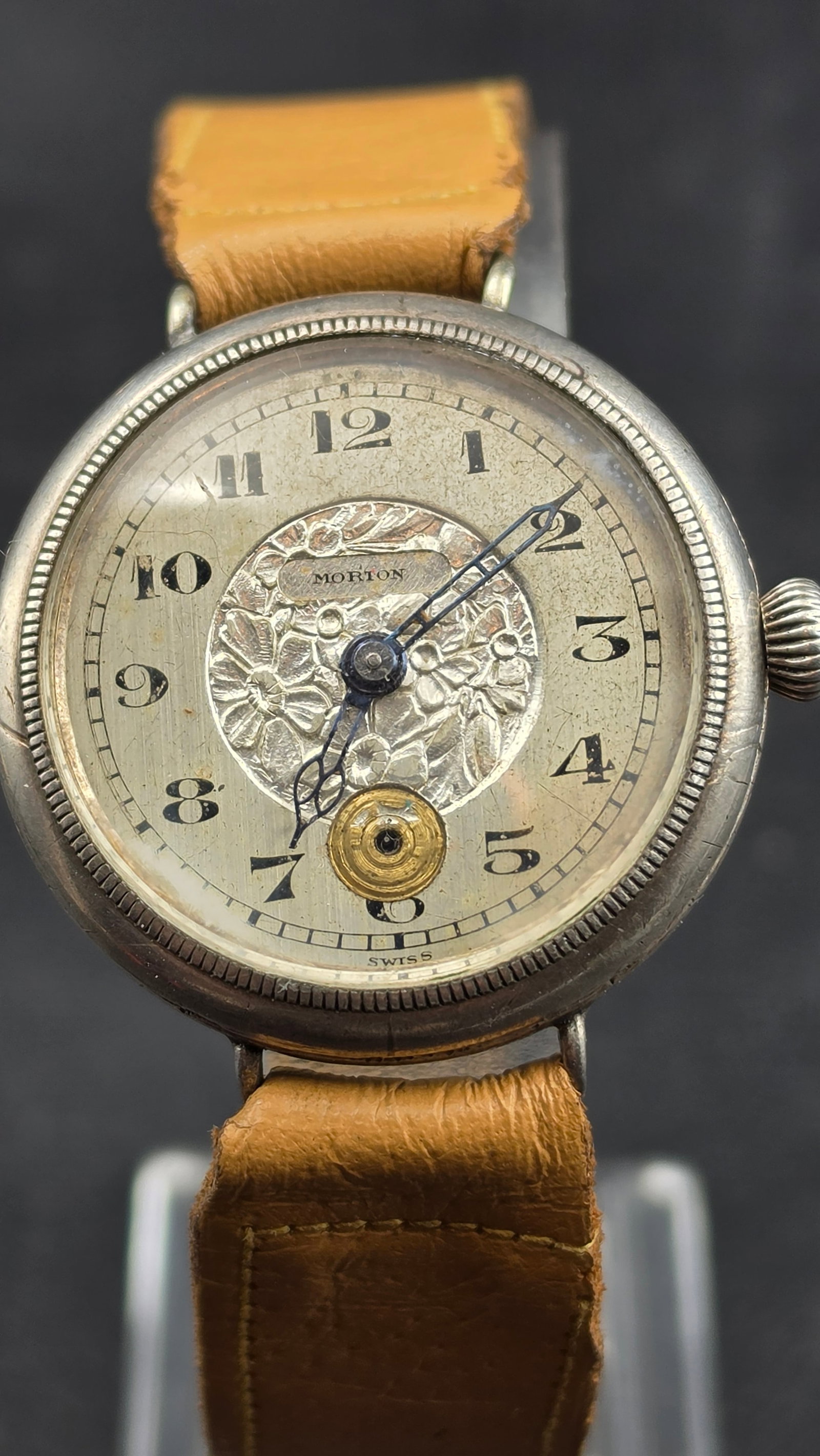 Antique WWI Era Morton Swiss Sterling Silver 925 Trench Watch 15J 3 Adj Floral Dial 34mm: Up for sale is an antique circa WWI-era Swiss trench wristwatch retailed under the Morton name. The silver dial features an ornate embossed floral center medallion with black printed Arabic numeral ho
