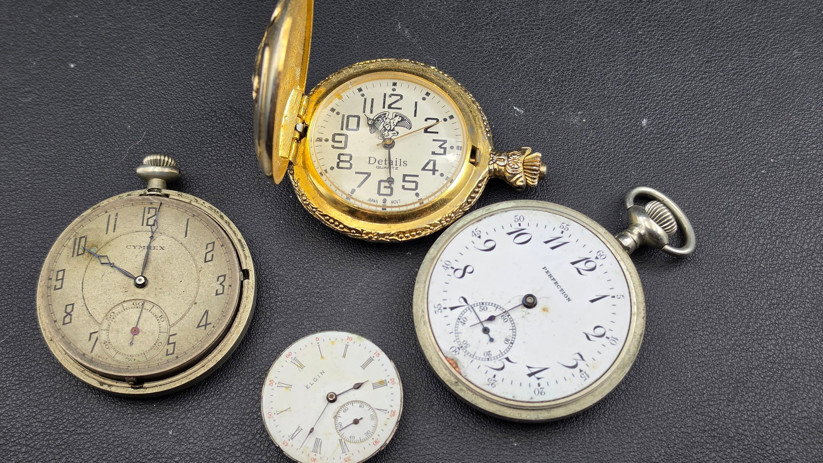 Antique Pocket Watch Lot 4 Pieces Cyprex Swiss Perfection Elgin Movement Details Quartz Parts Repair: Up for sale is a lot of four antique and vintage pocket watch pieces offered together for collectors, watchmakers, and parts enthusiasts. The first is a Cyprex Watch Co. Geneve Swiss open-face pocket 