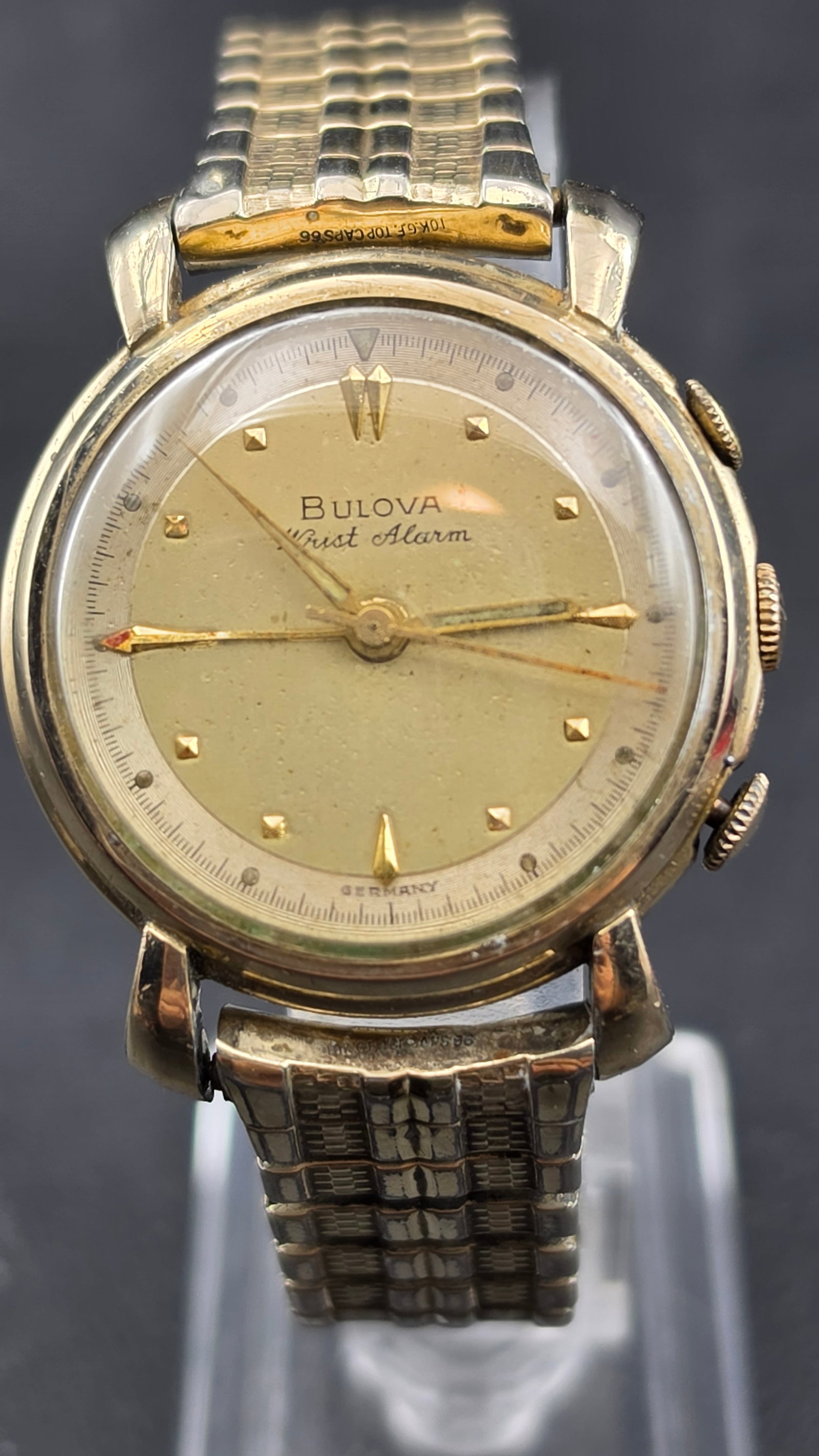 Vintage 1950s Bulova Wrist Alarm Germany Cal 12-8 17 Jewel 10K GF Mechanical Men's Watch: Up for sale is a vintage 1950s Bulova Wrist Alarm men's mechanical wristwatch, featuring the German-made caliber 12-8 movement, 17 jewels, visible through the open case back. The case back is stamped 