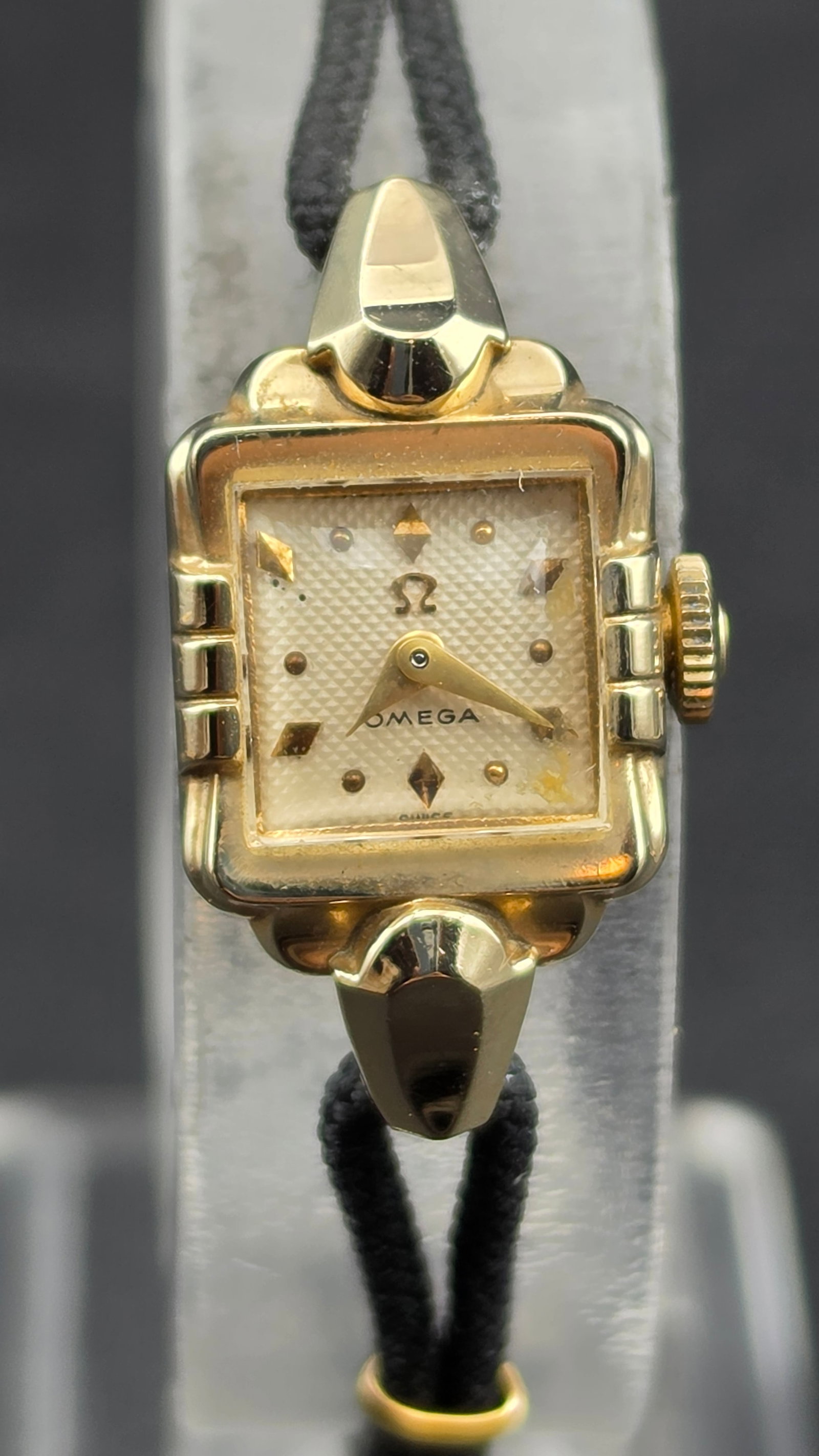 1955 Omega Ladies 17J Cal 490 Square Watch 14K GF Ref A5245 Cord Bracelet Runs 13mm: Up for sale is a 1955–1956 Omega ladies wristwatch powered by caliber 490, serial 14,443,589. The case reference A5245 is stamped inside the Omega-signed inner dust cover alongside the Omega triangl