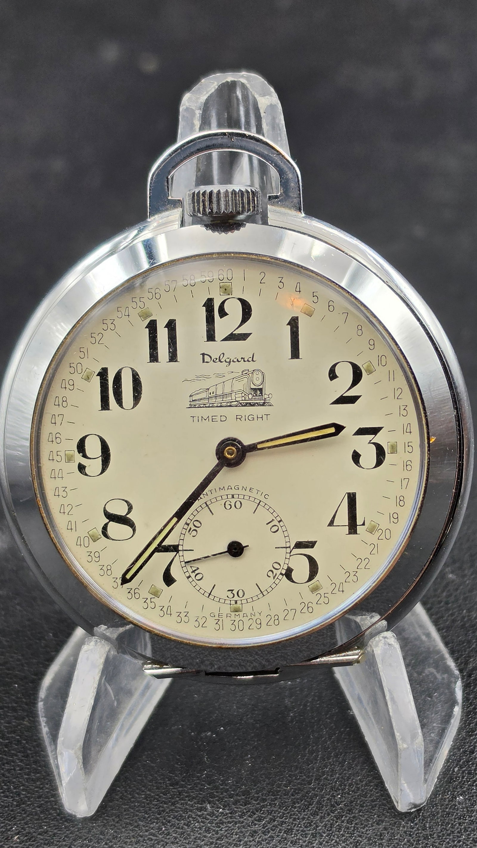 Vintage Delgard Timed Right Antimagnetic German Made Pocket Watch Locomotive Dial Runs: Offered here is a vintage Delgard "Timed Right" antimagnetic pocket watch, German made by the Delaware Watch Company. The dial is a standout feature: signed "Delgard / TIMED RIGHT" with a detailed pri