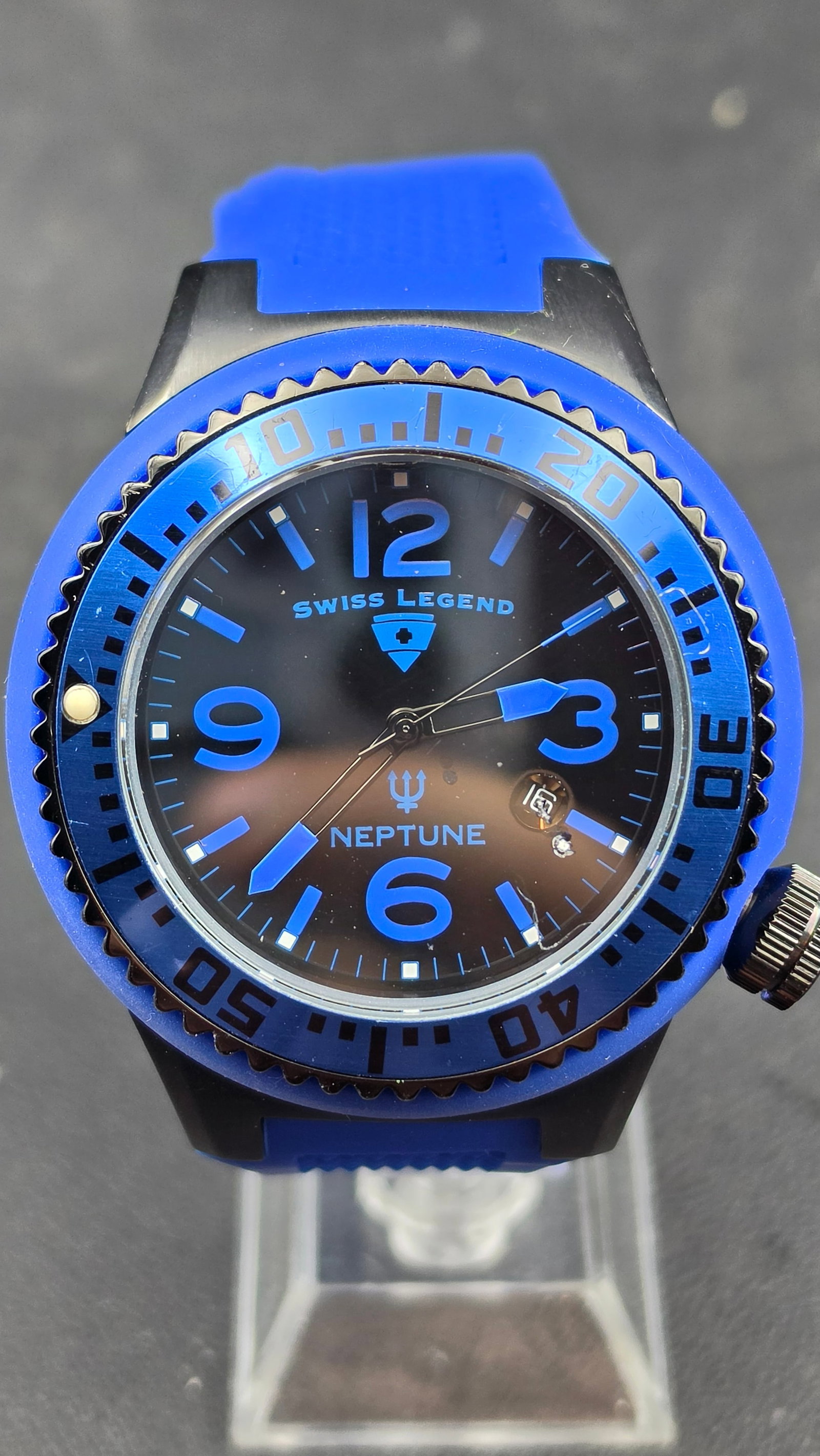 Swiss Legend Neptune Black Ion Plated Blue Dial Date Quartz Silicone Strap 53mm 2012: This is a Swiss Legend Neptune diver, powered by a Swiss quartz movement. The 52.89mm black ion-plated stainless steel case presents a black dial with bold blue Arabic numerals at 12, 9, 6, and 3, blu