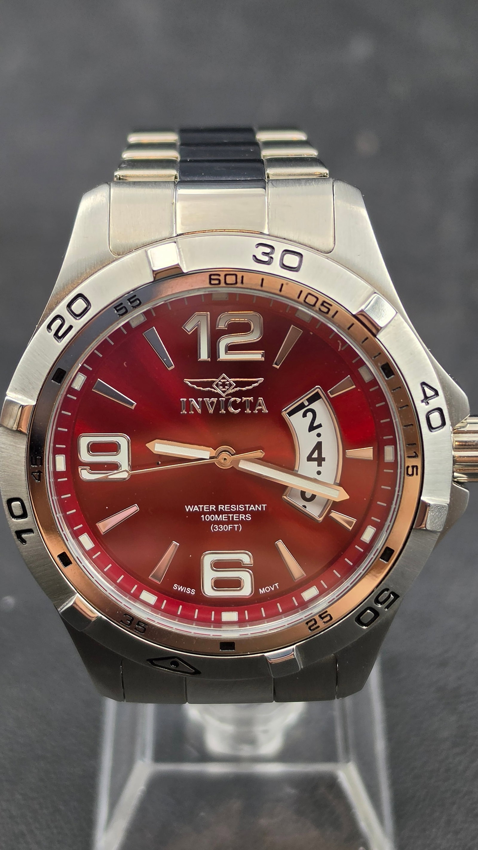 Invicta 0084 Red Sunburst Dial Date Swiss Parts Movement Stainless Steel Watch 45mm circa 2000s: This is an Invicta reference 0084, a 45mm all stainless steel sport watch powered by a Swiss Parts movement and fitted with a Flame-Fusion crystal. The vivid red sunburst dial carries the Invicta wing