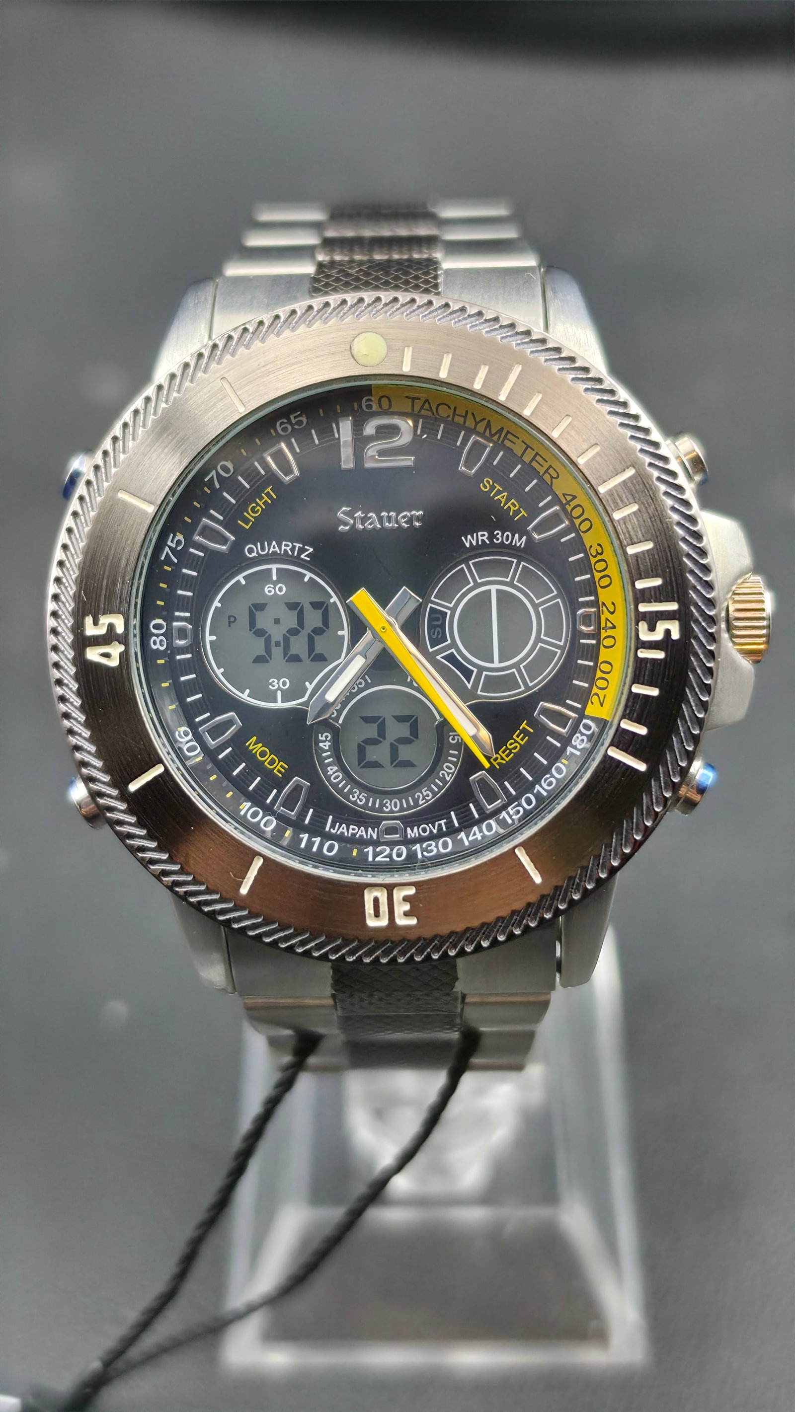 Stauer 20410 Ana-Digi Tachymeter Yellow Accent Japan Movement Stainless Steel Watch 46mm with Tag ci: This is a Stauer reference 20410, a 46mm stainless steel ana-digi sport watch with original hang tag still attached, powered by a Japanese quartz movement. The black dial combines analog and digital d