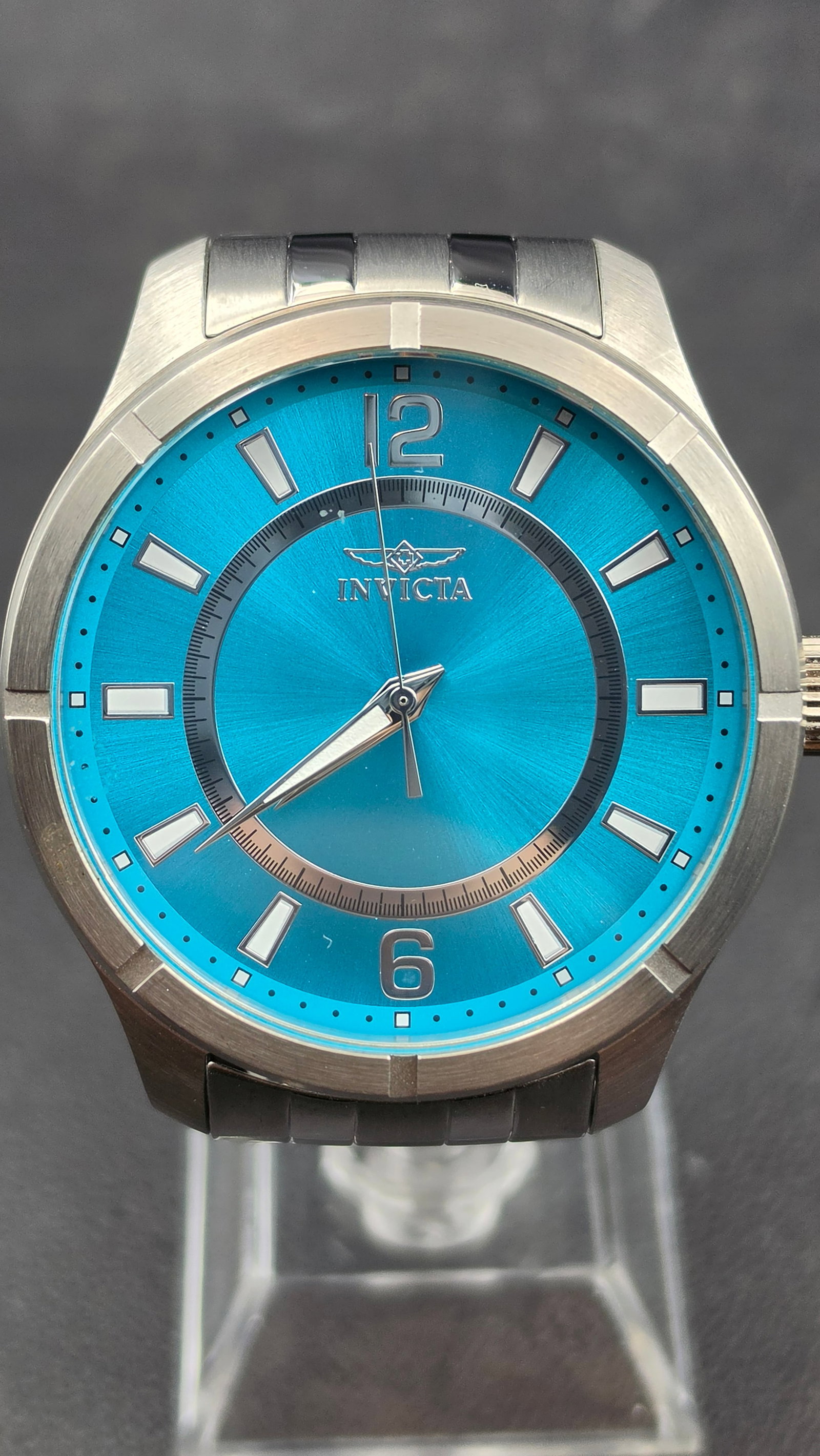 Invicta Specialty Model 19207 NOS 45mm Teal Blue Sunray Dial Tritnite Men's Watch: Invicta Specialty reference 19207, NOS example presenting in excellent unissued condition. The 45.12mm brushed and polished stainless steel case features a smooth fixed bezel with a two-tier design ��